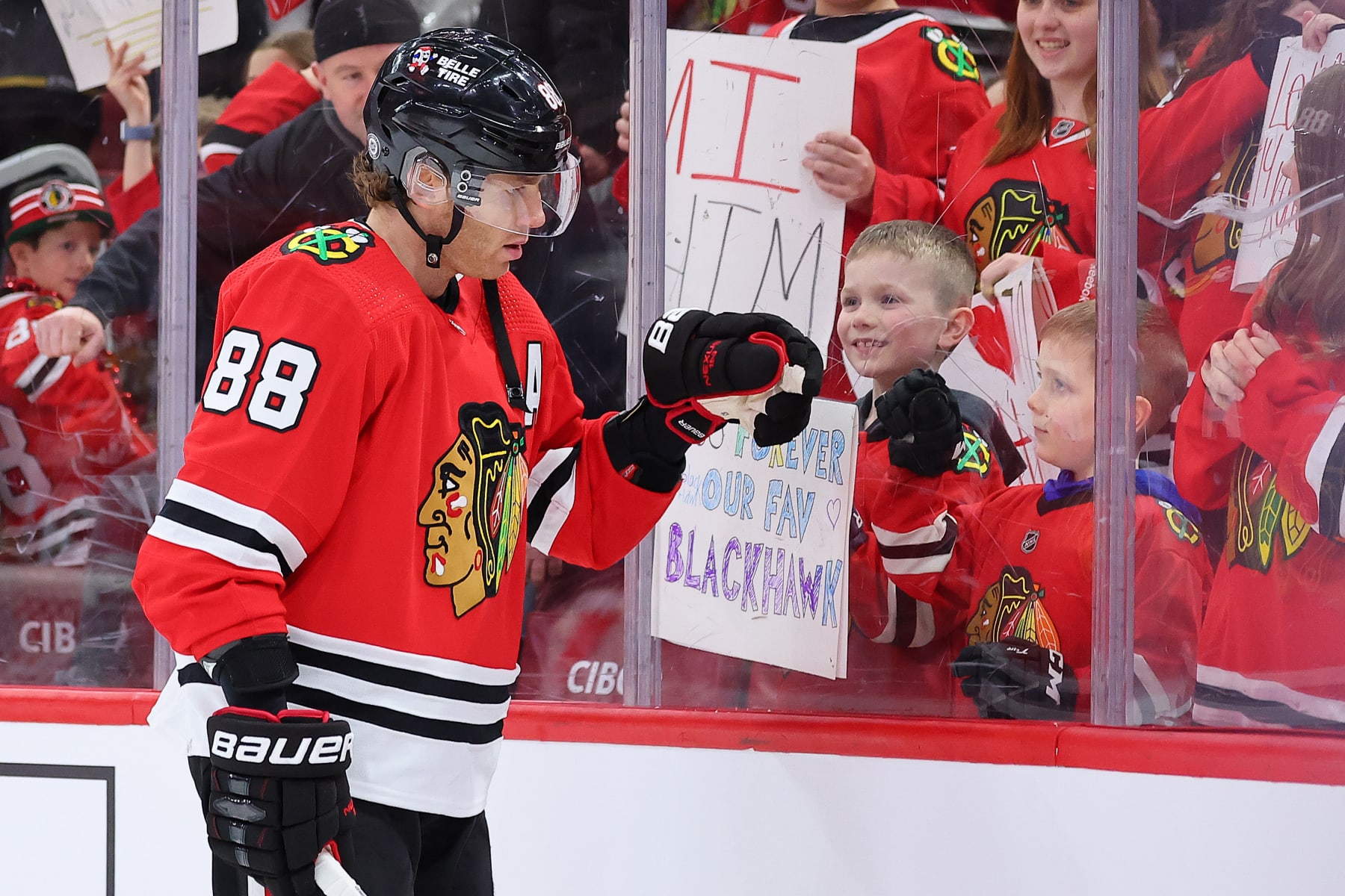 CHICAGO, ILLINOIS - FEBRUARY 21: Patrick Kane #88 of the Chicago Blackhawks fist bumps a young fan prior to the game against the Vegas Golden Knights at United Center on February 21, 2023 in Chicago, Illinois. (Photo by Michael Reaves/Getty Images)