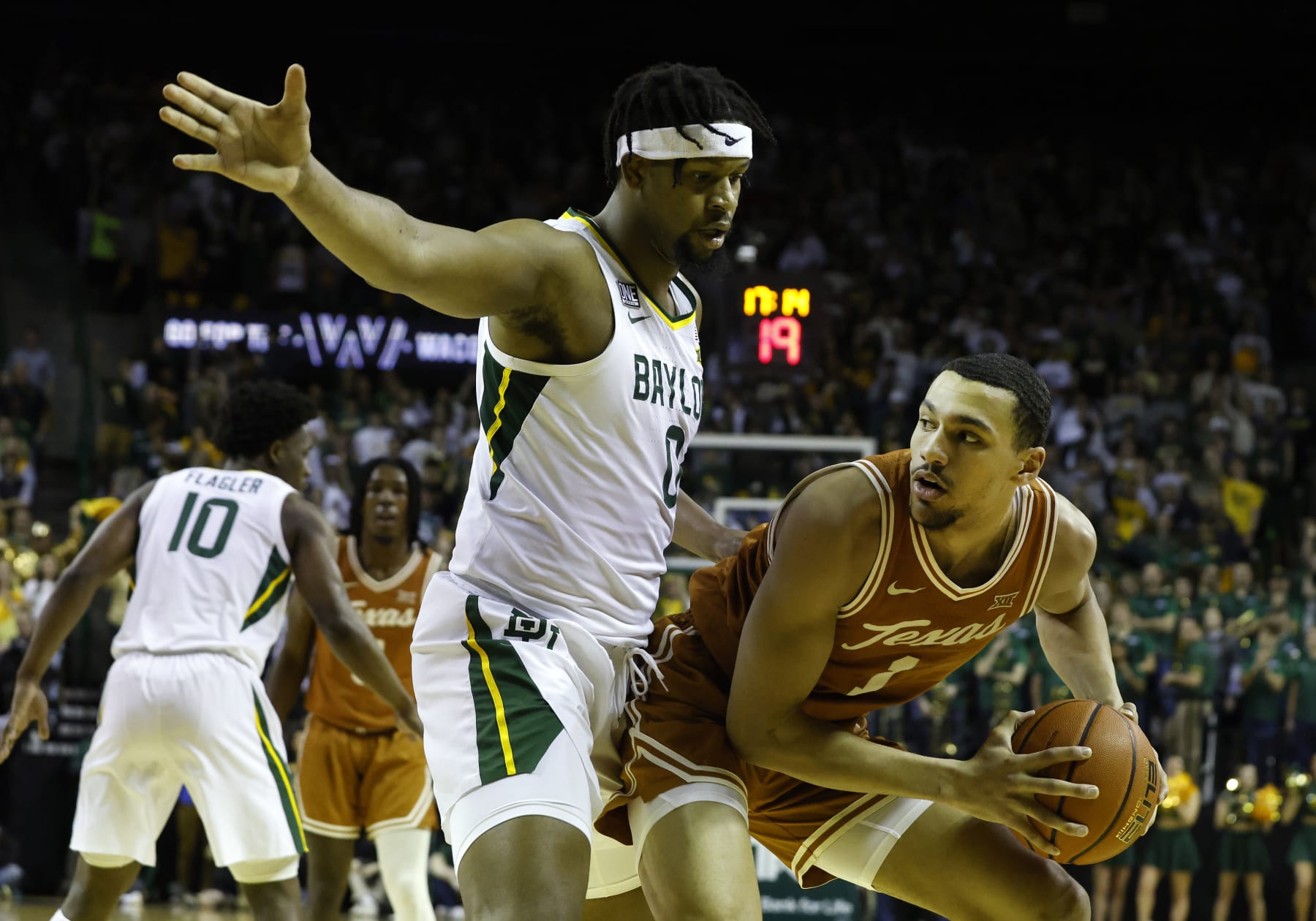 WACO, TX - FEBRUARY 25: Texas Longhorns forward Dylan Disu (1) dribbles past Baylor Bears forward Flo Thamba (0) during the game at the Ferrell Center in Waco, TX on February 25, 2023. (Photo by Adam Davis/Icon Sportswire via Getty Images)