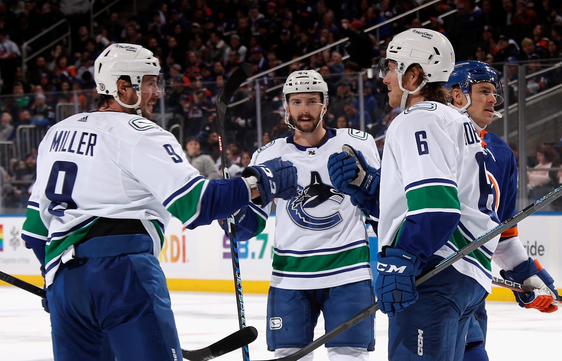 ELMONT, NEW YORK - FEBRUARY 09: Brock Boeser #6 of the Vancouver Canucks (R) celebrates his first period goal against the New York Islanders and is joined by Conor Garland #8 (L) and Kyle Burroughs #44 (C) at UBS Arena on February 09, 2023 in Elmont, New York. (Photo by Bruce Bennett/Getty Images)