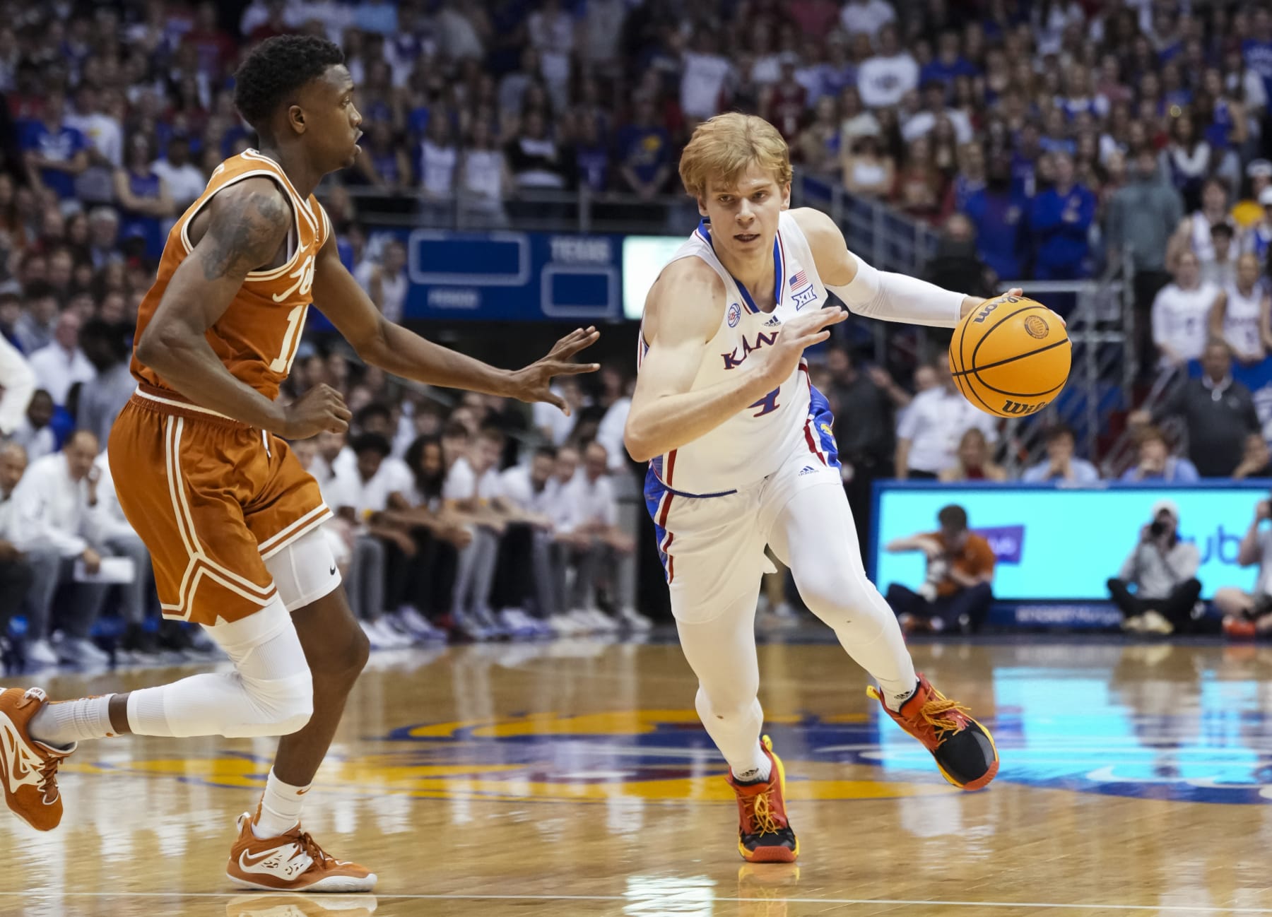 ]LAWRENCE, KS - FEBRUARY 06: Gradey Dick #4 of the Kansas Jayhawks drives against SirJabari Rice #10 of the Texas Longhorns during the first half at Allen Fieldhouse on February 6, 2023 in Lawrence, Kansas. (Photo by Jay Biggerstaff/Getty Images)