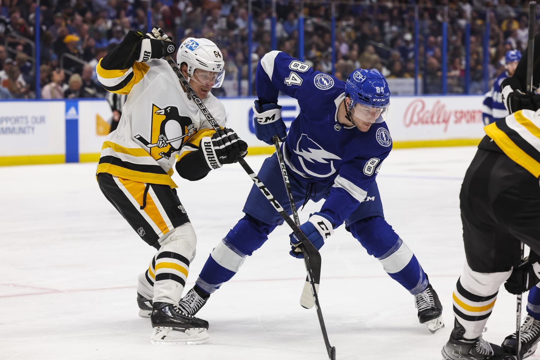 Pittsburgh's Mikael Granlund tries to tie up Tampa Bay's Tanner Jeannot in a battle of new acquisitions.