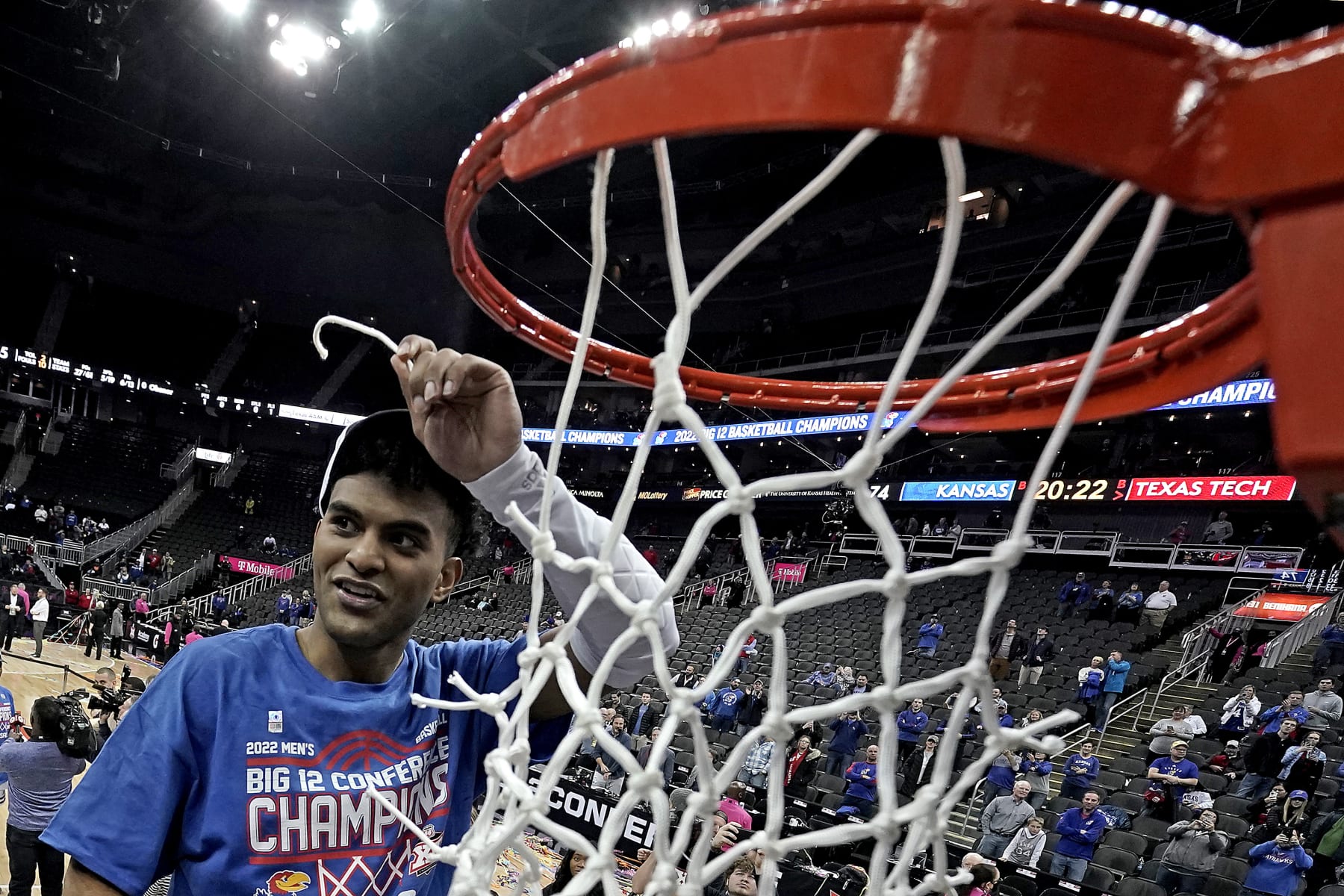 Kansas guard Remy Martin cuts the net after an NCAA college basketball championship game against Texas Tech in the Big 12 Conference tournament in Kansas City, Mo., Saturday, March 12, 2022. Kansas won 74-65. (AP Photo/Charlie Riedel)