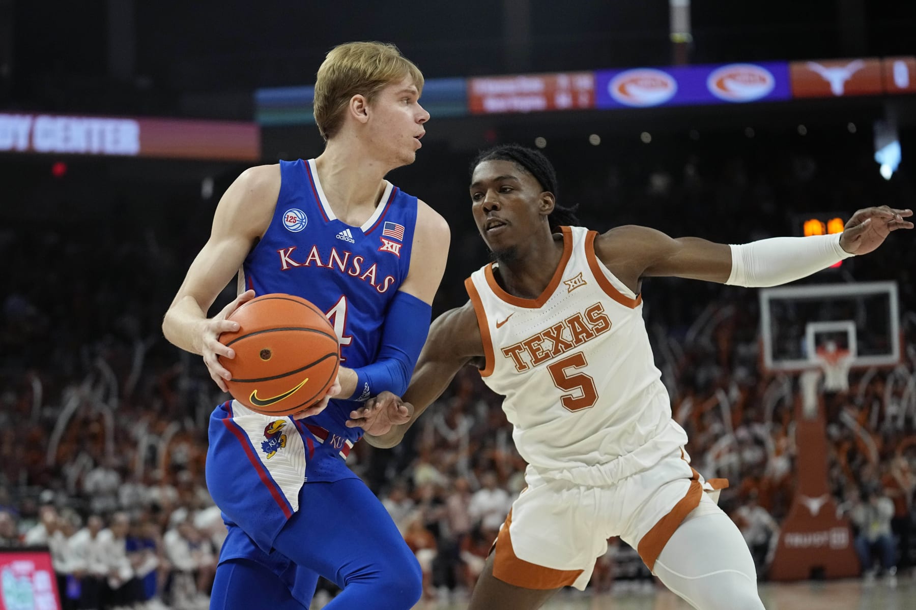 Kansas guard Gradey Dick (4) drives around Texas guard Marcus Carr (5)during the first half of an NCAA college basketball game in Austin, Texas, Saturday, March 4, 2023. (AP Photo/Eric Gay)
