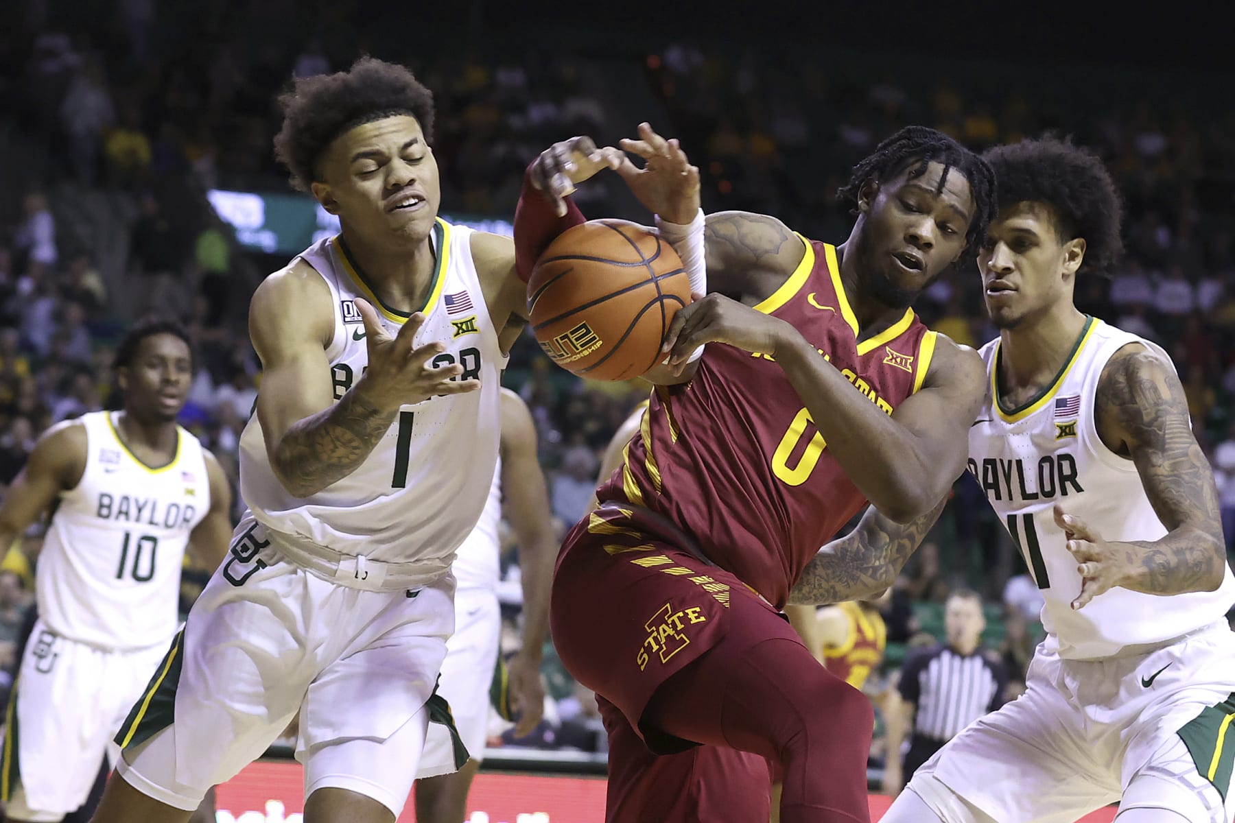 Baylor guard Keyonte George (1) and Iowa State forward Tre King (0) reach for a loose ball during the first half of an NCAA college basketball game Saturday, March 4, 2023, in Waco, Texas. (AP Photo/Jerry Larson)