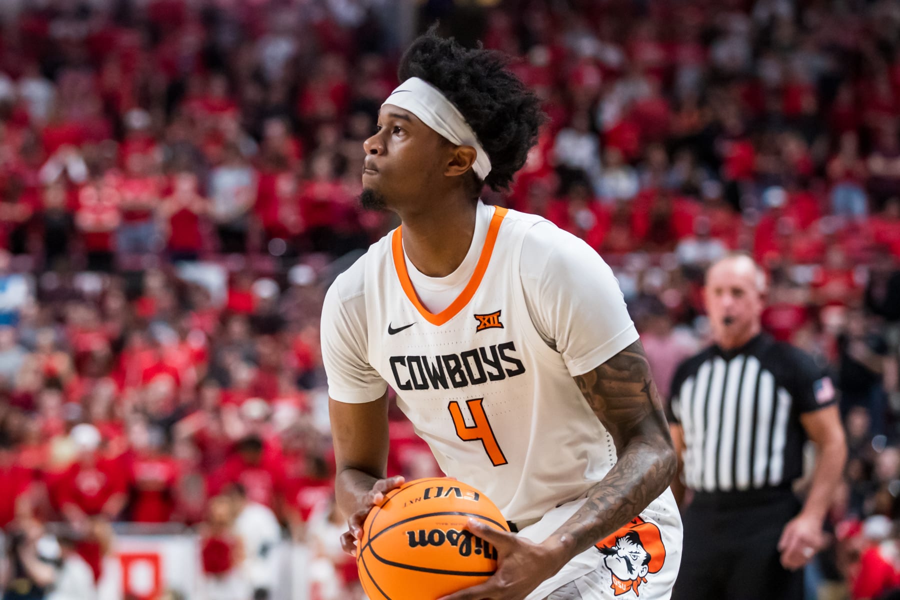 LUBBOCK, TEXAS - MARCH 04: Guard Woody Newton #4 of the Oklahoma State Cowboys shoots the ball during the first half of the college basketball game against the Texas Tech Red Raiders at United Supermarkets Arena on March 04, 2023 in Lubbock, Texas. (Photo by John E. Moore III/Getty Images)