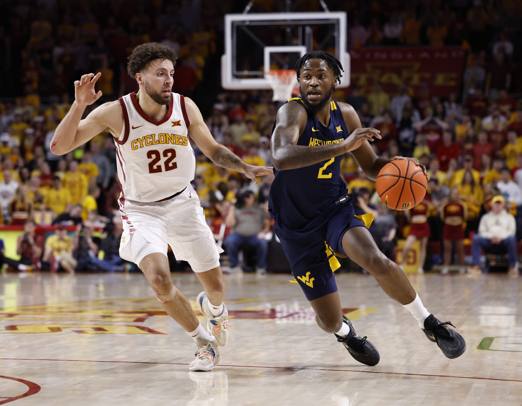 AMES, IA - FEBRUARY 27: Kobe Johnson #2 of the West Virginia Mountaineers drives the ball as Gabe Kalscheur #22 of the Iowa State Cyclones defends in the second half of play at Hilton Coliseum on February 27, 2023 in Ames, Iowa. The West Virginia Mountaineers won 72-69 over the Iowa State Cyclones. (Photo by David K Purdy/Getty Images)