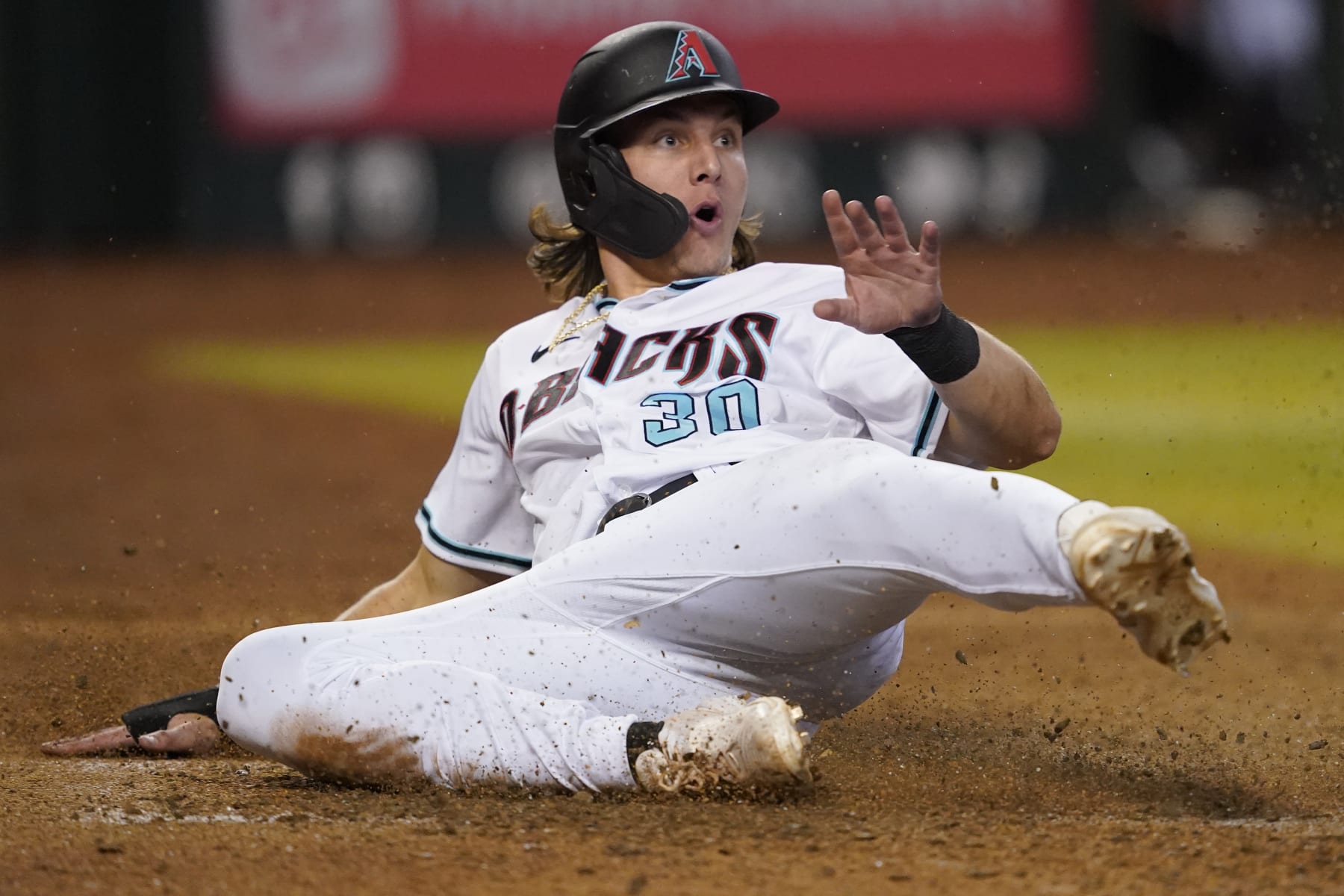 Arizona Diamondbacks' Jake McCarthy (30) looks at the umpire after being called out at the plate on a fielders choice hit into by Daulton Varsho during the eighth inning of a baseball game against the San Diego Padres, Thursday, Sept. 15, 2022, in Phoenix. (AP Photo/Matt York)