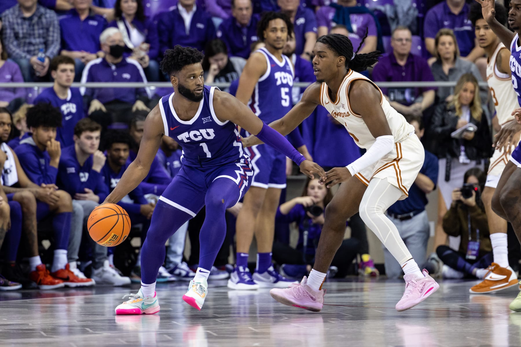 FORT WORTH, TX - FEBRUARY 11: TCU Horned Frogs guard Mike Miles Jr. (#1) dribbles up court as Texas Longhorns guard Marcus Carr (#5) defends during the college basketball game between the TCU Horned Frogs and Texas Longhorns on March 1, 2023 at Ed & Rae Schollmaier Arena in Fort Worth, Texas. (Photo by Matthew Visinsky/Icon Sportswire via Getty Images)