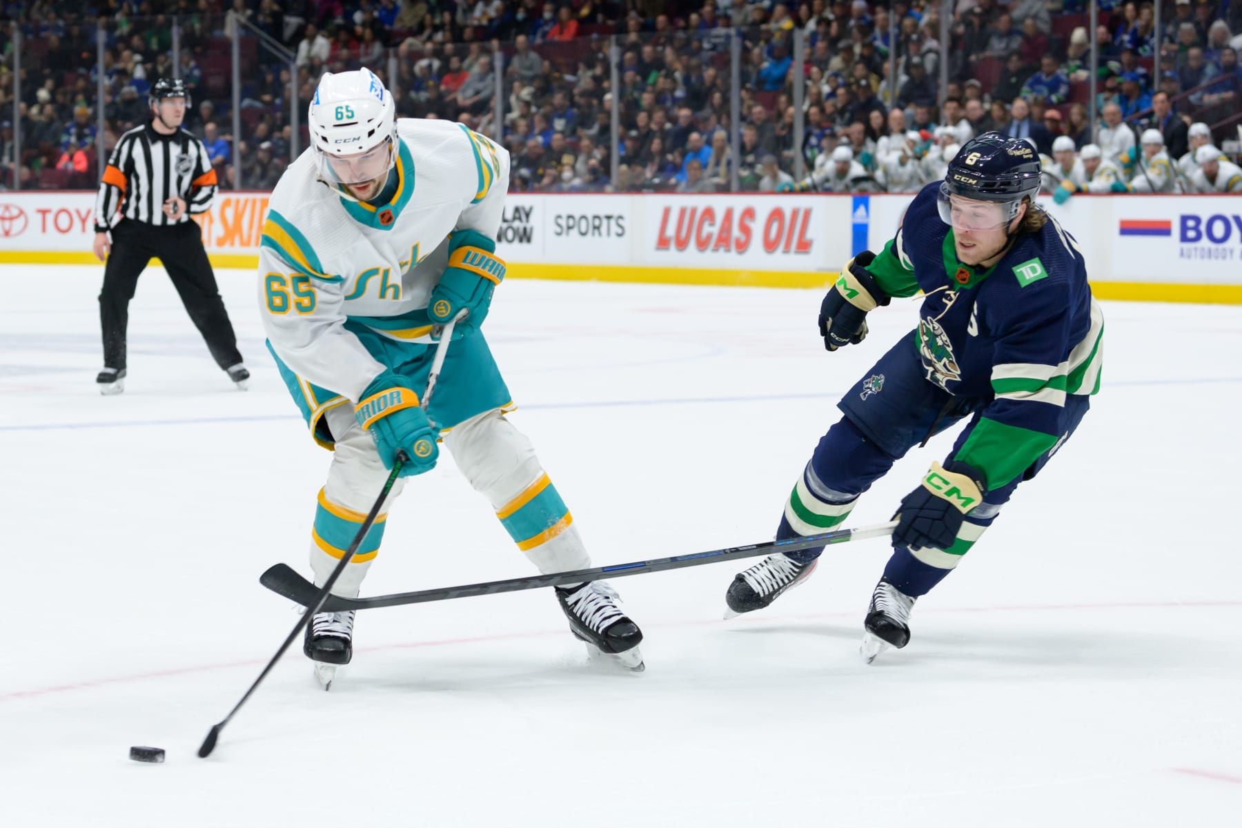 San Jose Sharks defenseman Erik Karlsson (left) and Vancouver Canucks winger Brock Boeser
