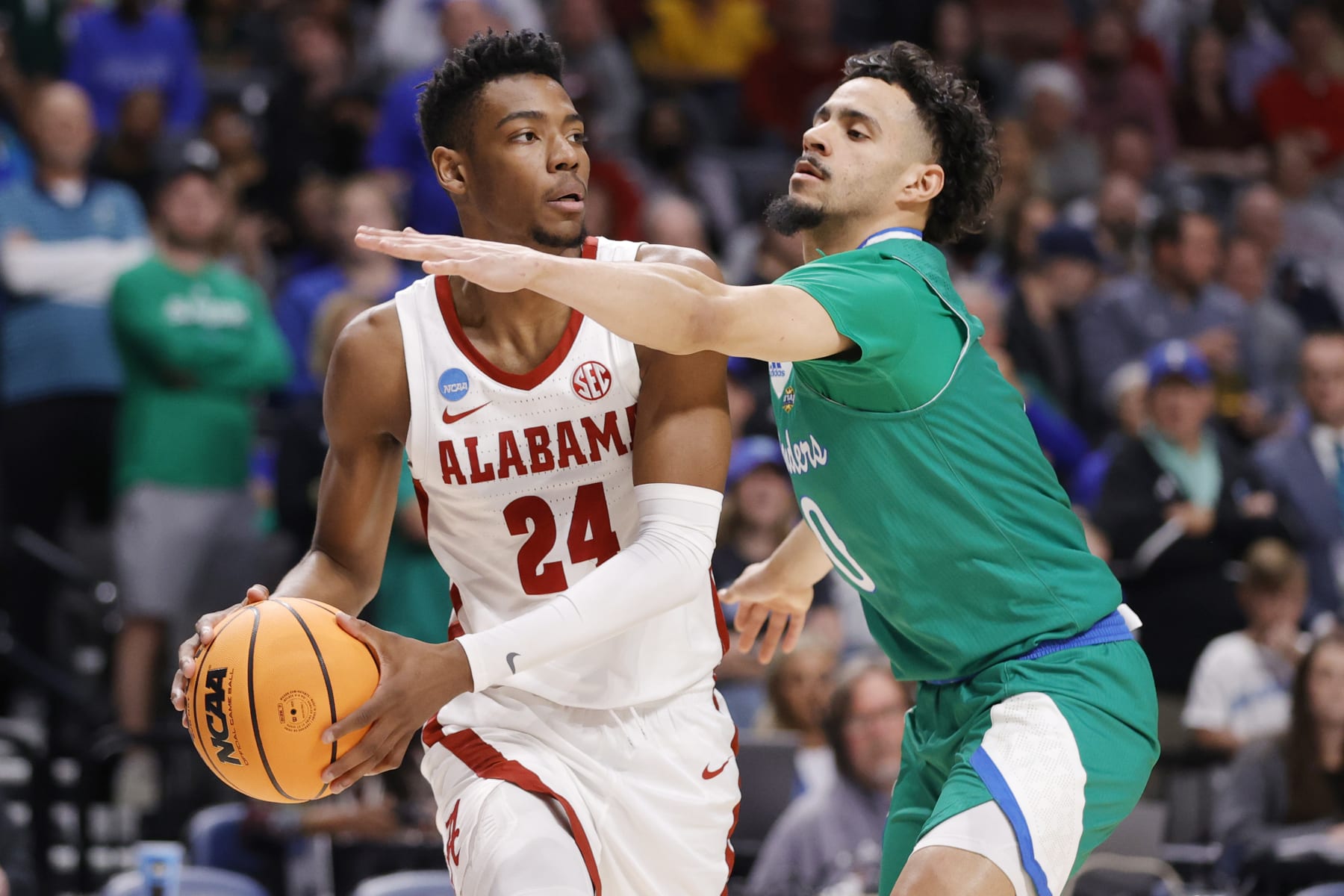 BIRMINGHAM, ALABAMA - MARCH 16: Brandon Miller #24 of the Alabama Crimson Tide looks to pass against Trevian Tennyson #0 of the Texas A&M-CC Islanders during the first half in the first round of the NCAA Men's Basketball Tournament at Legacy Arena at the BJCC on March 16, 2023 in Birmingham, Alabama. (Photo by Alex Slitz/Getty Images)