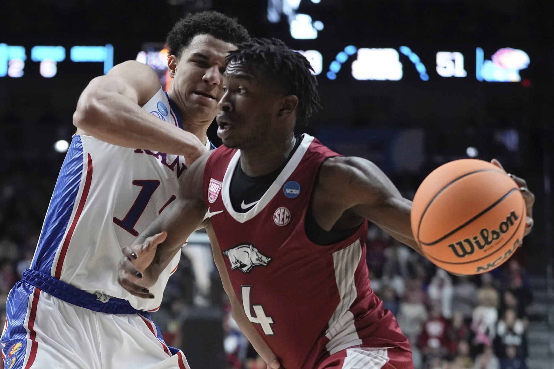 Arkansas' Davonte Davis drives by Kansas' Kevin McCullar Jr. during the second half of a second-round college basketball game in the NCAA Tournament Saturday, March 18, 2023, in Des Moines, Iowa. (AP Photo/Morry Gash)
