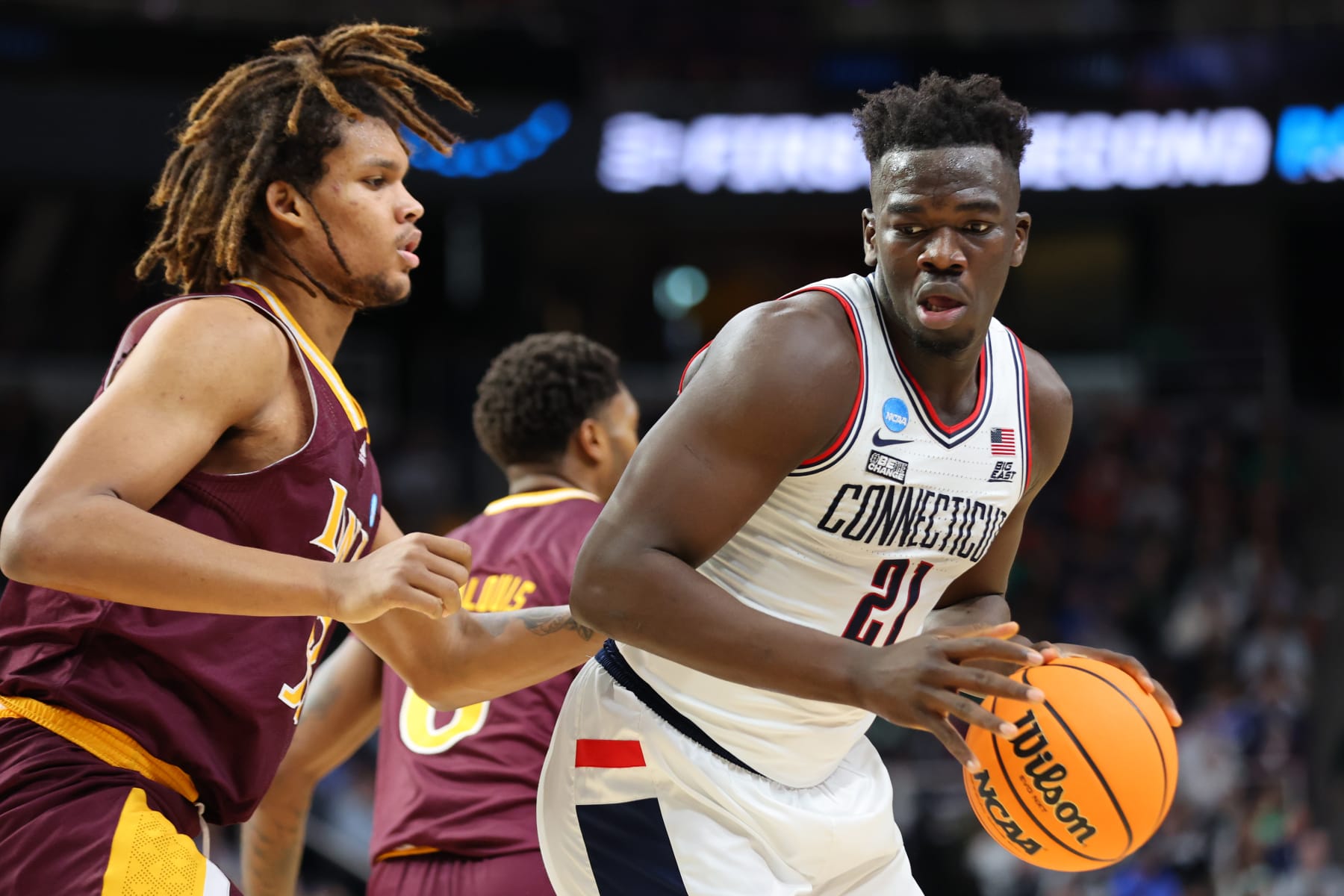 ALBANY, NY - MARCH 17: Adama Sanogo #21 of the Connecticut Huskies dribbles against Silas Sunday #33 of the Iona Gaels during the first round of the 2023 NCAA Men's Basketball Tournament held at MVP Arena on March 17, 2023 in Albany, New York. (Photo by C. Morgan Engel/NCAA Photos via Getty Images) ALBANY, NY - MARCH 17: Adama Sanogo #21 of the Connecticut Huskies dribbles against Silas Sunday #33 of the Iona Gaels during the first round of the 2023 NCAA Men's Basketball Tournament held at MVP Arena on March 17, 2023 in Albany, New York. (Photo by C. Morgan Engel/NCAA Photos via Getty Images)
