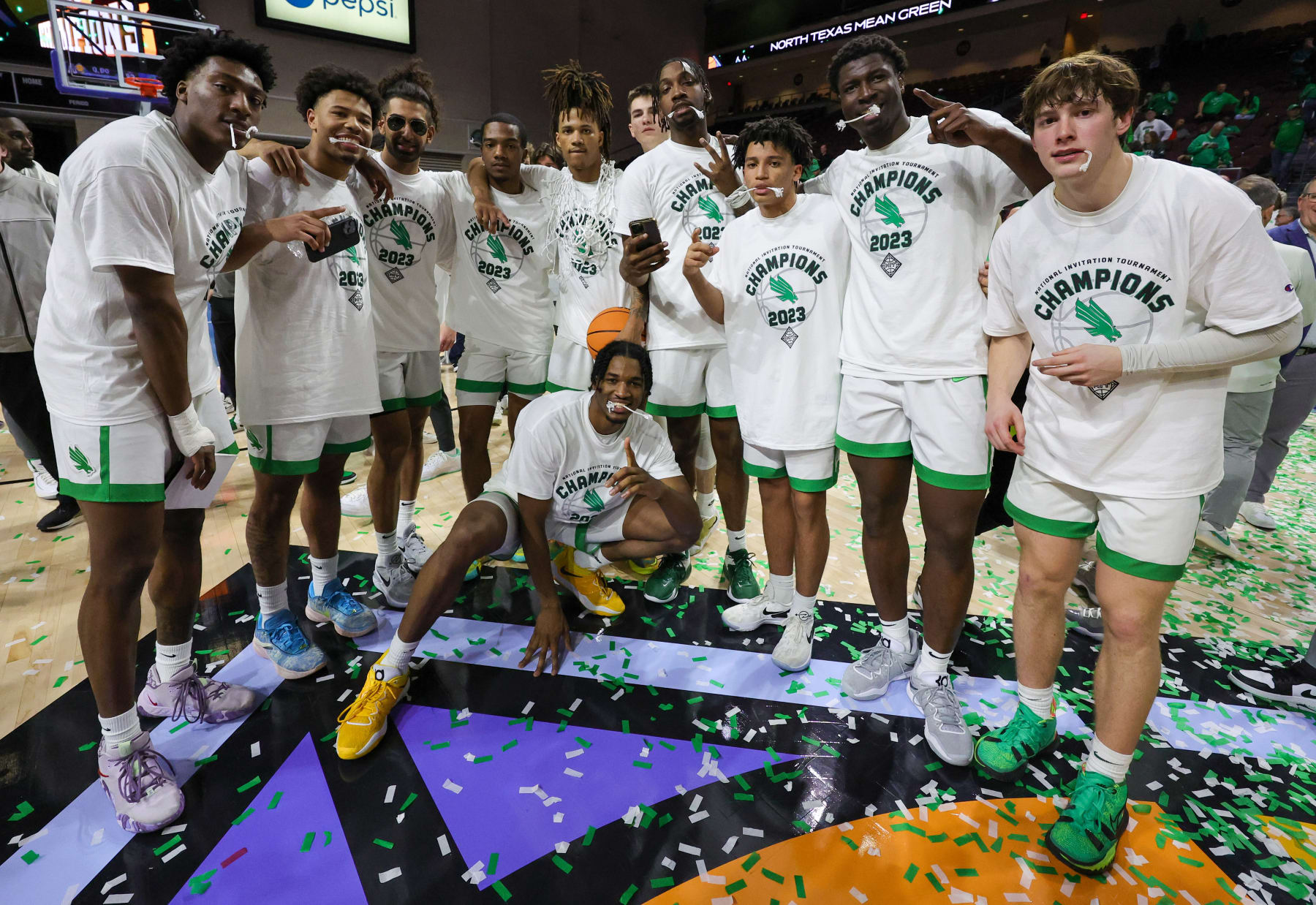 LAS VEGAS, NEVADA - MARCH 30: The North Texas Mean Green pose for photos on the court as they celebrate their 68-61 victory over the UAB Blazers to win the championship game of the NIT basketball tournament at the Orleans Arena on March 30, 2023 in Las Vegas, Nevada. (Photo by Ethan Miller/Getty Images)