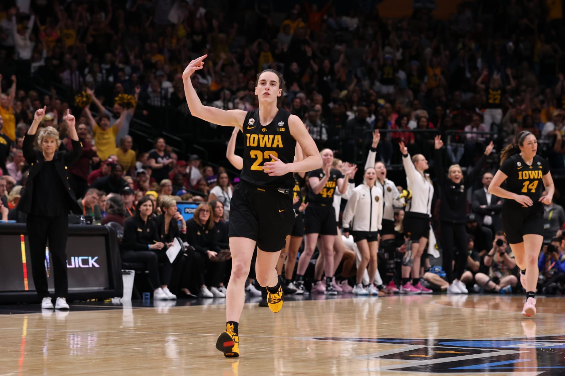 DALLAS, TEXAS - MARCH 31: Caitlin Clark #22 of the Iowa Hawkeyes reacts after a three point basket during the fourth quarter against the South Carolina Gamecocks during the 2023 NCAA Women's Basketball Tournament Final Four semifinal game at American Airlines Center on March 31, 2023 in Dallas, Texas. (Photo by Tom Pennington/Getty Images)