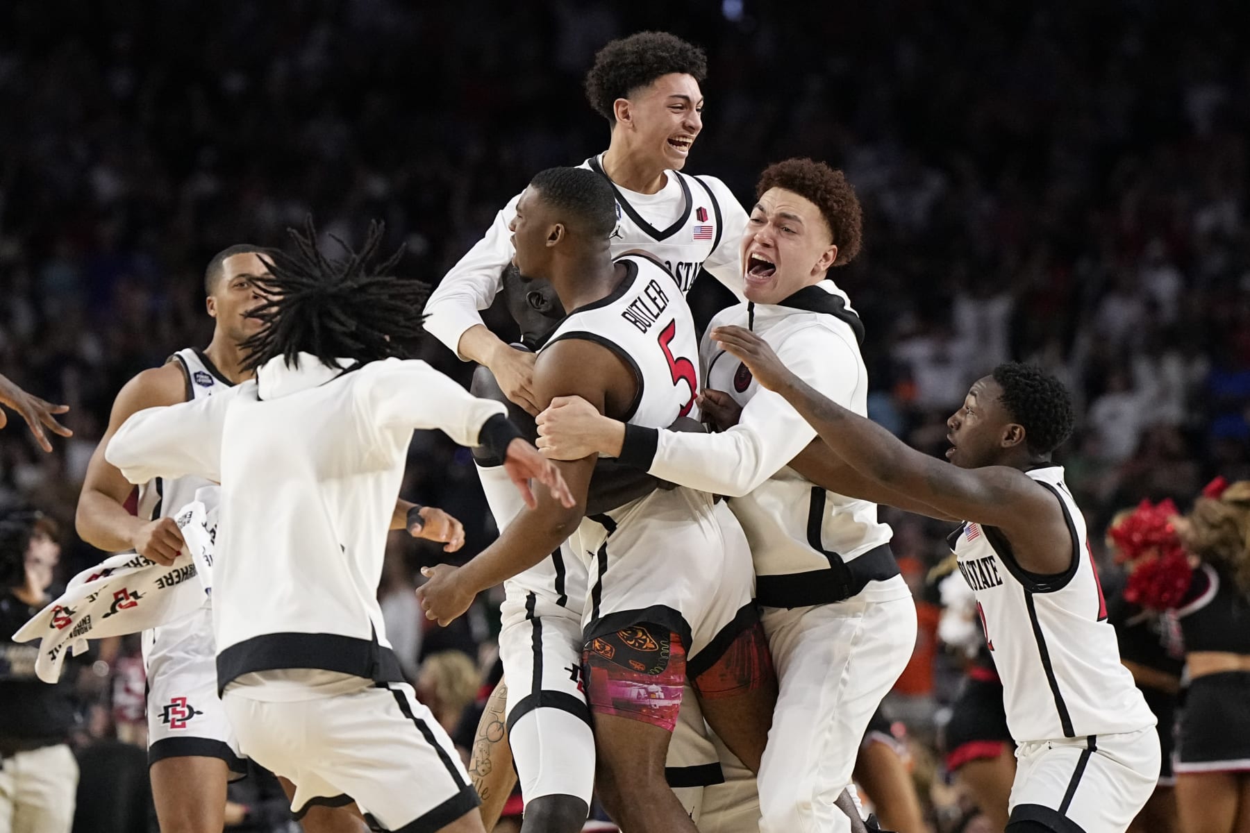 San Diego State guard Lamont Butler (5) celebrates with teammates after scoring the winning basket against Florida Atlantic during a Final Four college basketball game in the NCAA Tournament on Saturday, April 1, 2023, in Houston. (AP Photo/Brynn Anderson)