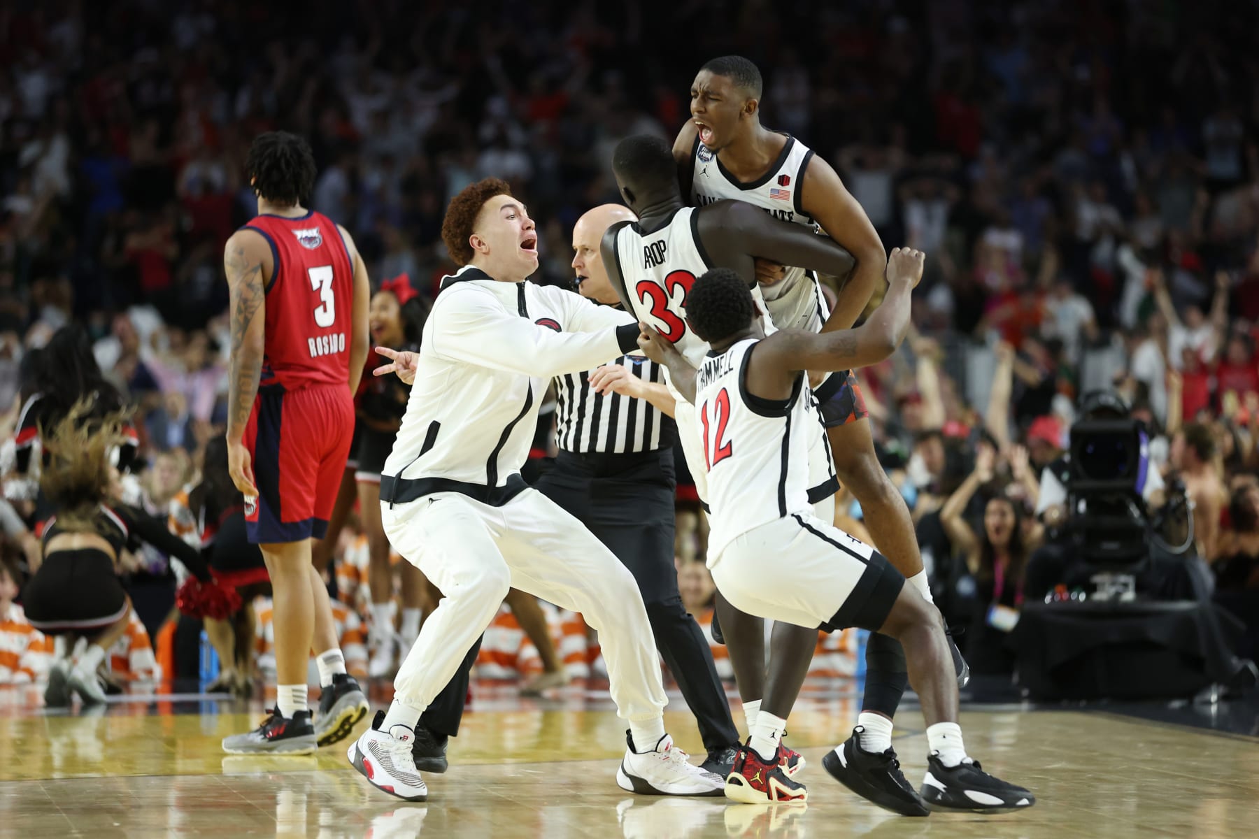 HOUSTON, TEXAS - APRIL 01: Lamont Butler #5 of the San Diego State Aztecs celebrates with teammates after making a game winning basket to defeat the Florida Atlantic Owls 72-71 during the NCAA Men's Basketball Tournament Final Four semifinal game at NRG Stadium on April 01, 2023 in Houston, Texas. (Photo by Gregory Shamus/Getty Images)