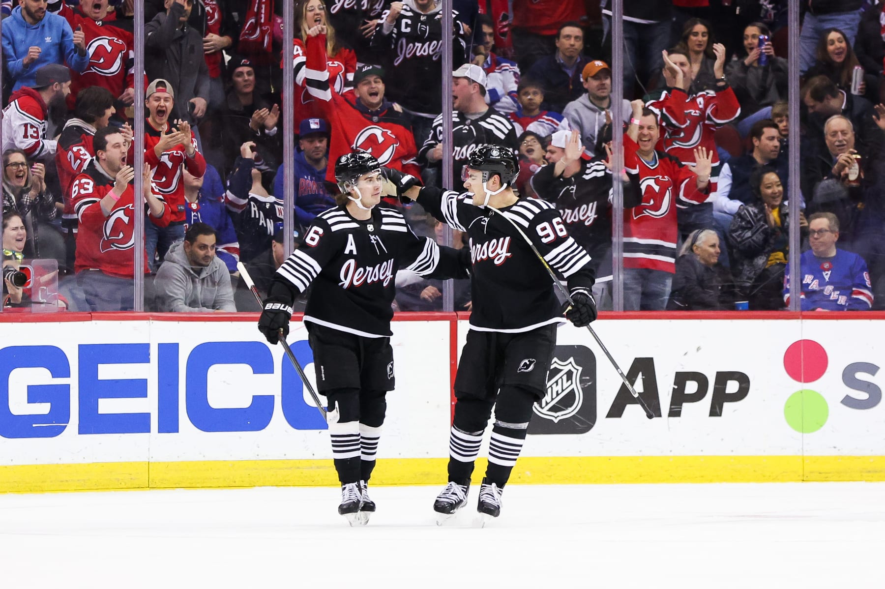 NEWARK, NJ - MARCH 30: New Jersey Devils right wing Timo Meier (96) celebrates with New Jersey Devils center Jack Hughes (86) after scoring a goal during the National Hockey League game between the New York Rangers and the New Jersey Devils on March 30, 2023 at Prudential Center in Newark, NJ. (Photo by Andrew Mordzynski/Icon Sportswire via Getty Images)
