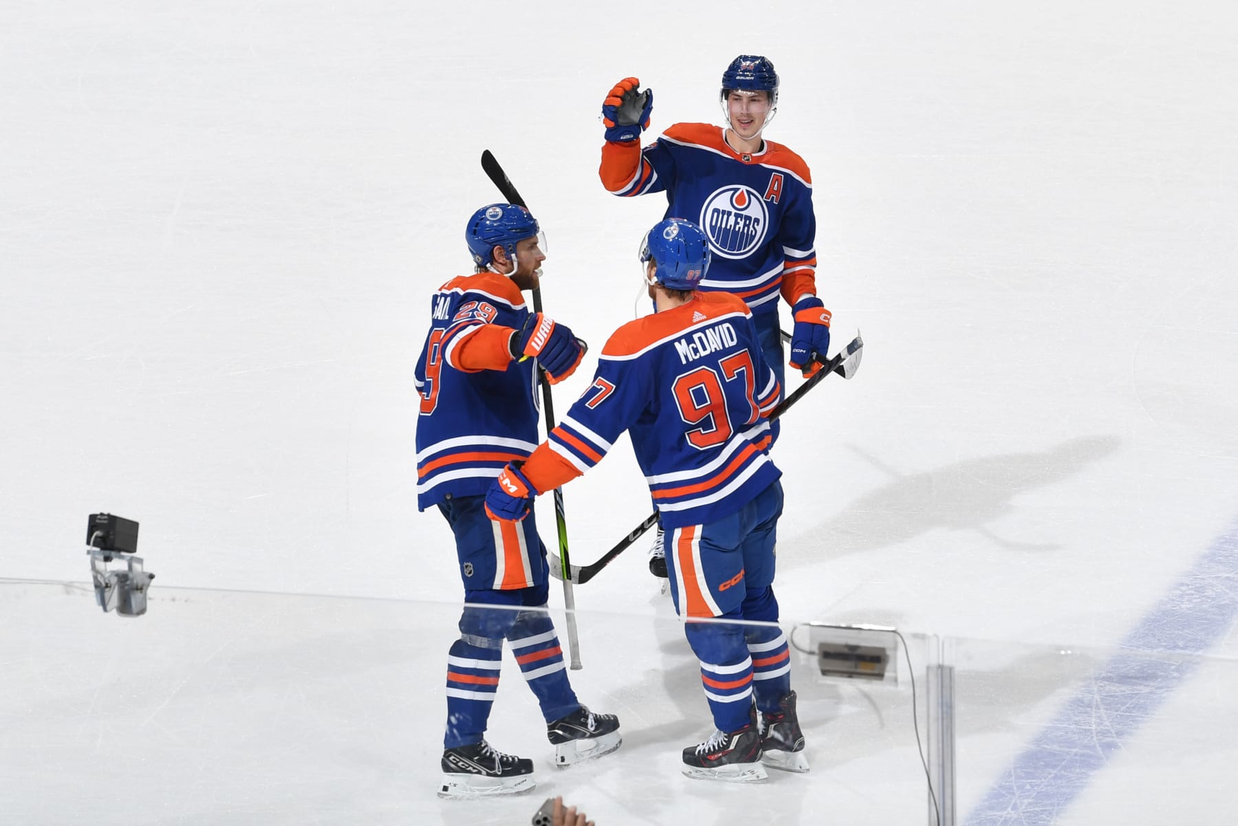 EDMONTON, CANADA - MARCH 22: Connor McDavid #97 of the Edmonton Oilers celebrates his overtime winner against the Arizona Coyotes and 60th goal of the season with Ryan Nugent-Hopkins #93 and Leon Draisaitl #29 on March 22, 2023 at Rogers Place in Edmonton, Alberta, Canada. (Photo by Andy Devlin/NHLI via Getty Images)