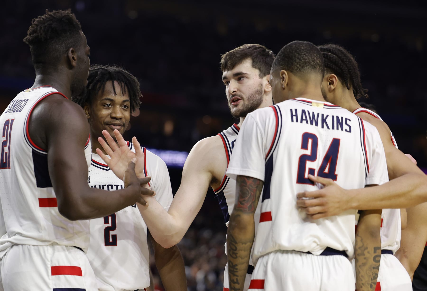 HOUSTON, TEXAS - APRIL 03: Alex Karaban #11 of the Connecticut Huskies celebrates with Adama Sanogo #21 during the second half against the San Diego State Aztecs during the NCAA Men's Basketball Tournament National Championship game at NRG Stadium on April 03, 2023 in Houston, Texas. (Photo by Carmen Mandato/Getty Images)