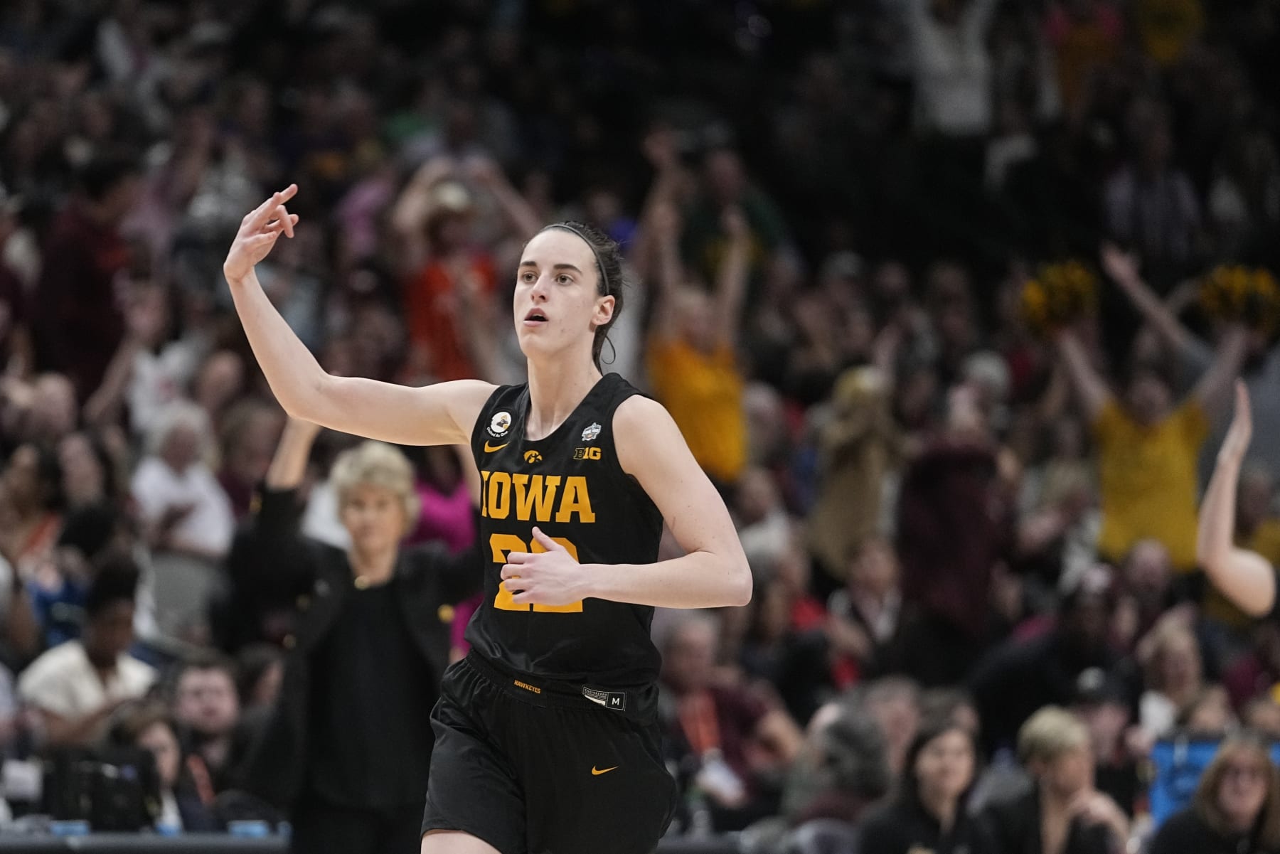 Iowa's Caitlin Clark reacts after a three pointer during the second half of an NCAA Women's Final Four semifinals basketball game against South Carolina Friday, March 31, 2023, in Dallas. (AP Photo/Darron Cummings)