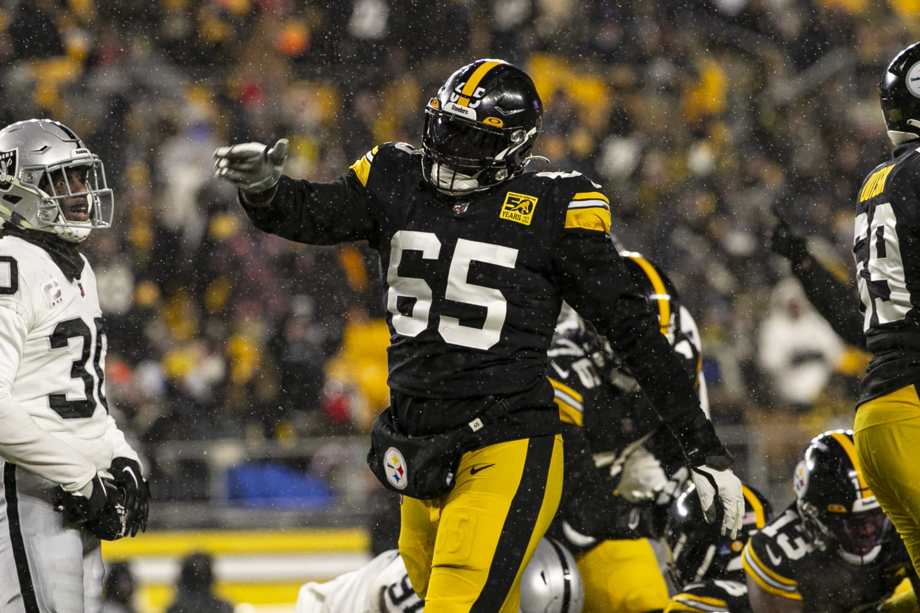 Dan Moore Jr. #65 of the Pittsburgh Steelers looks on against the News  Photo - Getty Images