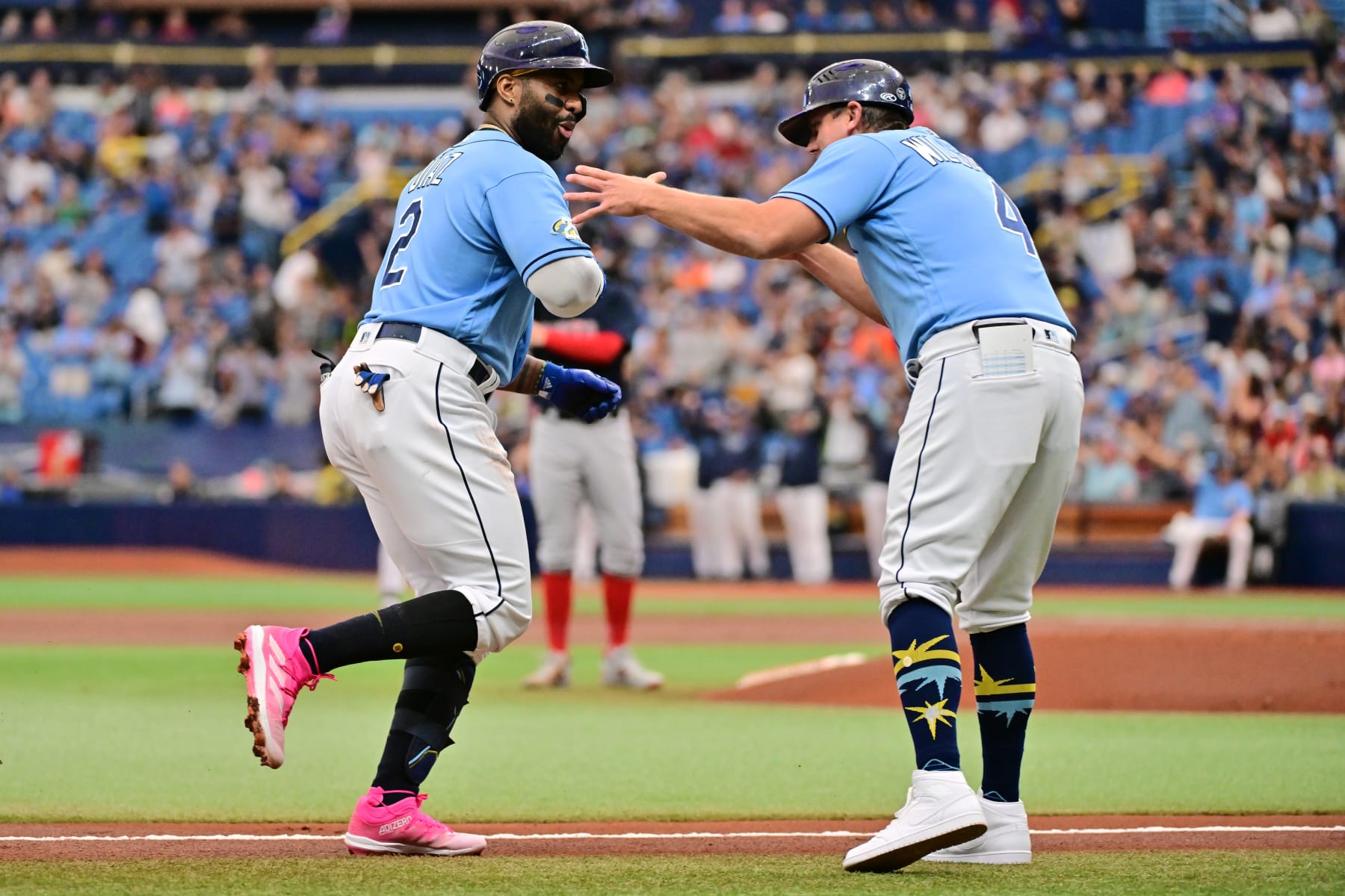 ST PETERSBURG, FLORIDA - APRIL 13: Yandy Diaz #2 celebrates with third base coach Brady Williams #4 of the Tampa Bay Rays after hitting a home run in the first inning against the Boston Red Sox at Tropicana Field on April 13, 2023 in St Petersburg, Florida. (Photo by Julio Aguilar/Getty Images)