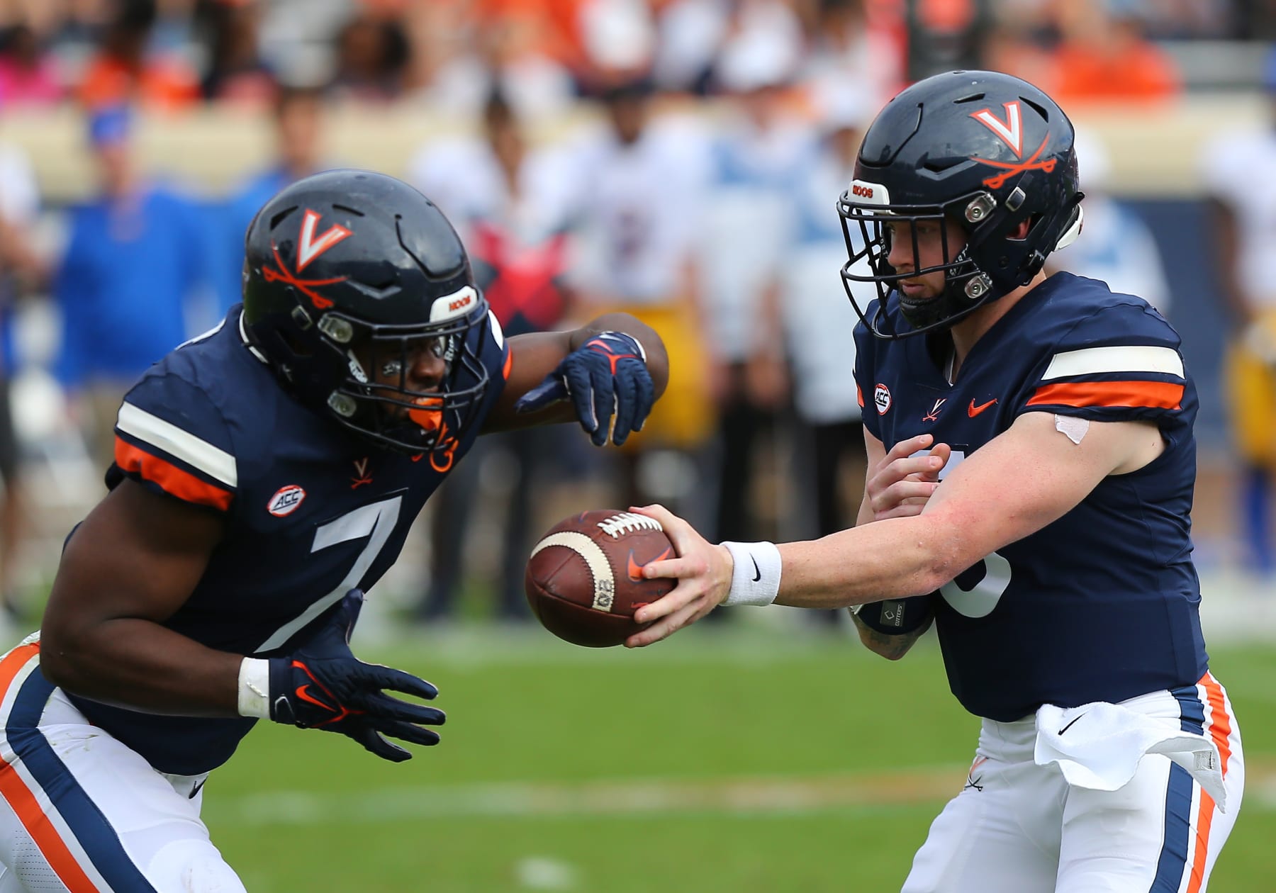 CHARLOTTESVILLE, VA - NOVEMBER 12: Virginia Cavaliers quarterback Brennan Armstrong (5) hands the ball to running back Mike Hollins (7) during a college football game between the Pittsburgh Panthers and the Virginia Cavaliers on November 12, 2022, at Scott Stadium in Charlottesville, VA. (Photo by Lee Coleman/Icon Sportswire via Getty Images)