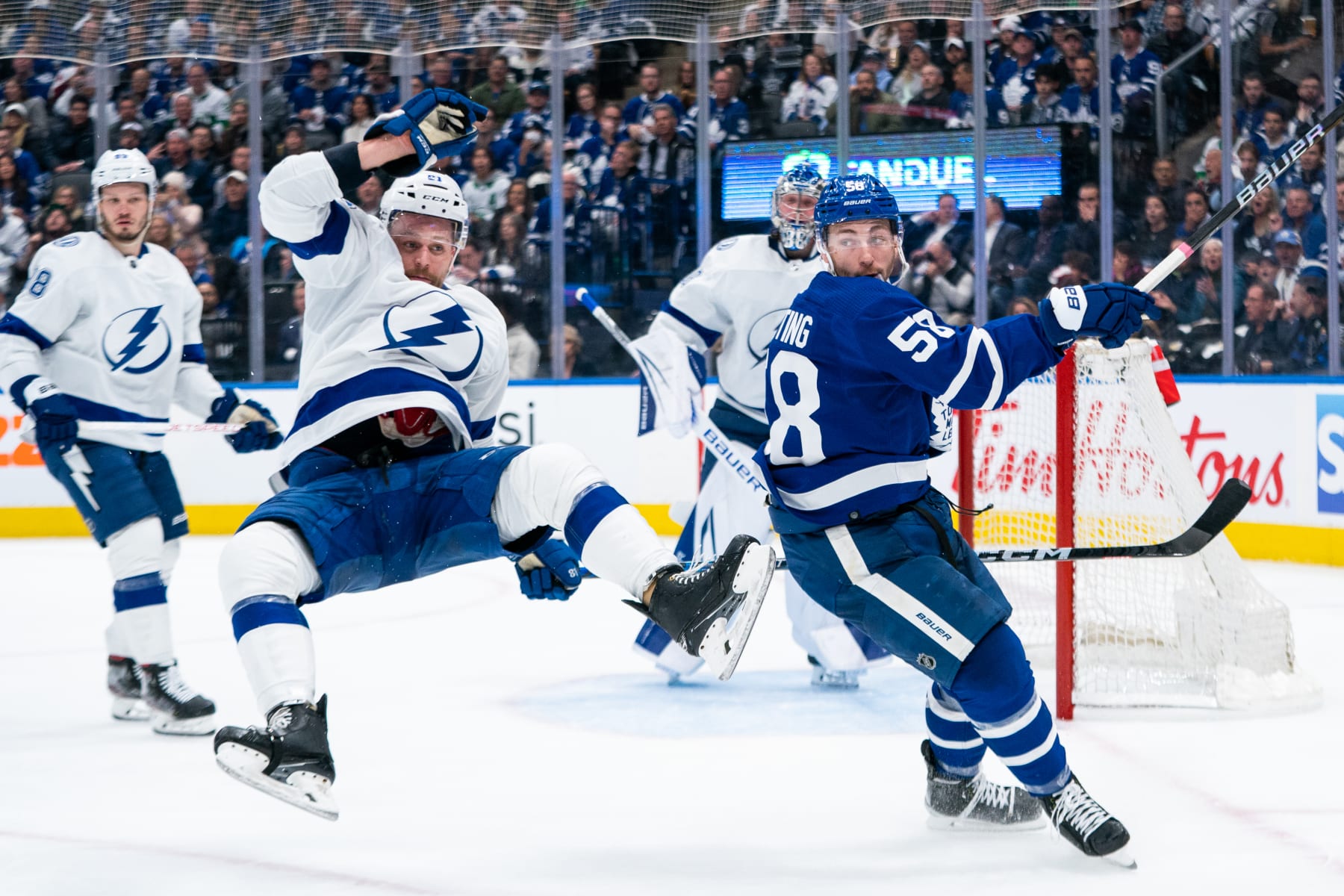 TORONTO, CANADA - APRIL 18: Michael Bunting #58 of the Toronto Maple Leafs hits Erik Cernak #81 of the Tampa Bay Lightning in Game One of the First Round of the 2023 Stanley Cup Playoffs at the Scotiabank Arena on April 18, 2023 in Toronto, Ontario, Canada. (Photo by Michael Chisholm/NHLI via Getty Images)