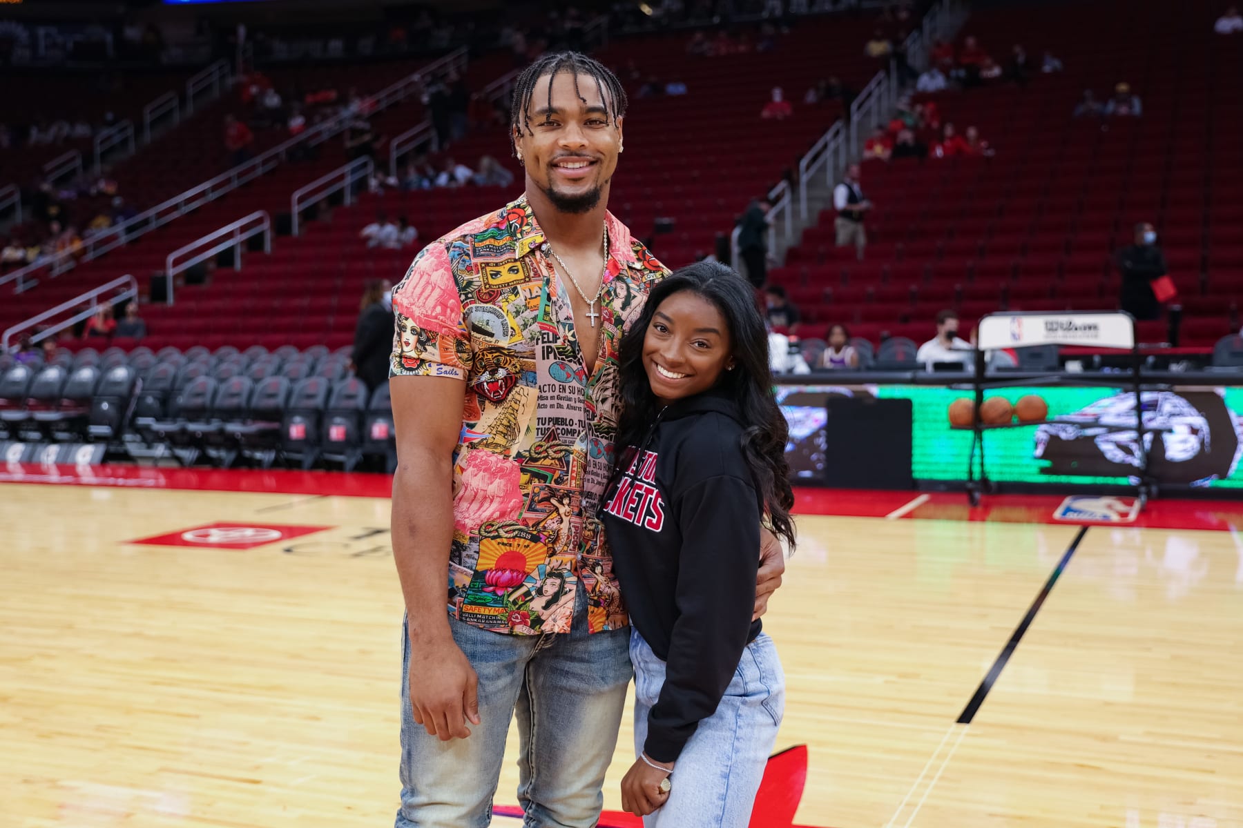 HOUSTON, TEXAS - DECEMBER 28: Simone Biles and Jonathan Owens attend a game between the Houston Rockets and the Los Angeles Lakers at Toyota Center on December 28, 2021 in Houston, Texas. NOTE TO USER: User expressly acknowledges and agrees that, by downloading and or using this photograph, User is consenting to the terms and conditions of the Getty Images License Agreement. (Photo by Carmen Mandato/Getty Images)