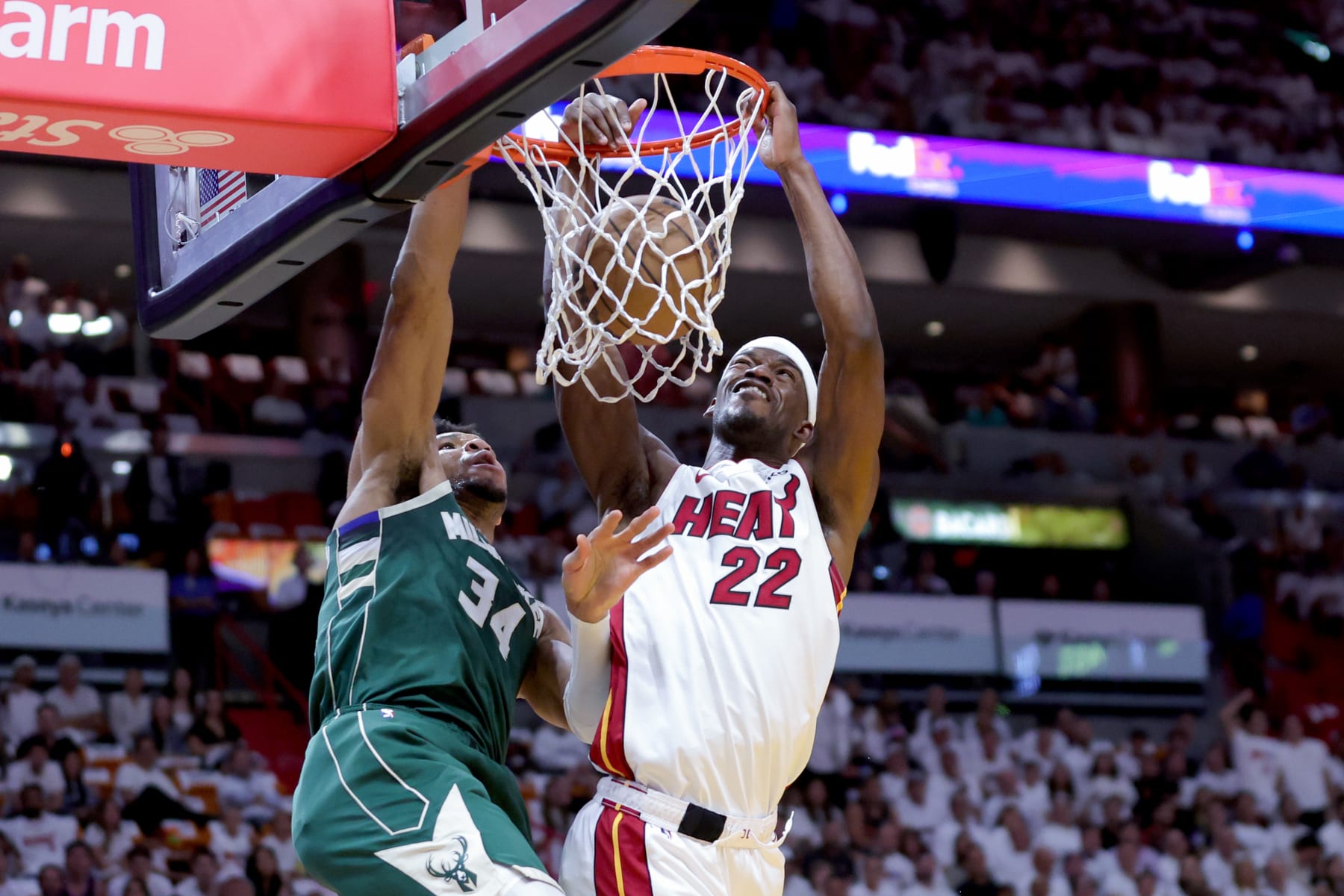 MIAMI, FLORIDA - APRIL 24: Jimmy Butler #22 of the Miami Heat dunks over Giannis Antetokounmpo #34 of the Milwaukee Bucks during the first quarter in Game Four of the Eastern Conference First Round Playoffs at Kaseya Center on April 24, 2023 in Miami, Florida. NOTE TO USER: User expressly acknowledges and agrees that, by downloading and or using this photograph, User is consenting to the terms and conditions of the Getty Images License Agreement. (Photo by Megan Briggs/Getty Images) MIAMI, FLORIDA - APRIL 24: Jimmy Butler #22 of the Miami Heat dunks over Giannis Antetokounmpo #34 of the Milwaukee Bucks during the first quarter in Game Four of the Eastern Conference First Round Playoffs at Kaseya Center on April 24, 2023 in Miami, Florida. NOTE TO USER: User expressly acknowledges and agrees that, by downloading and or using this photograph, User is consenting to the terms and conditions of the Getty Images License Agreement. (Photo by Megan Briggs/Getty Images)