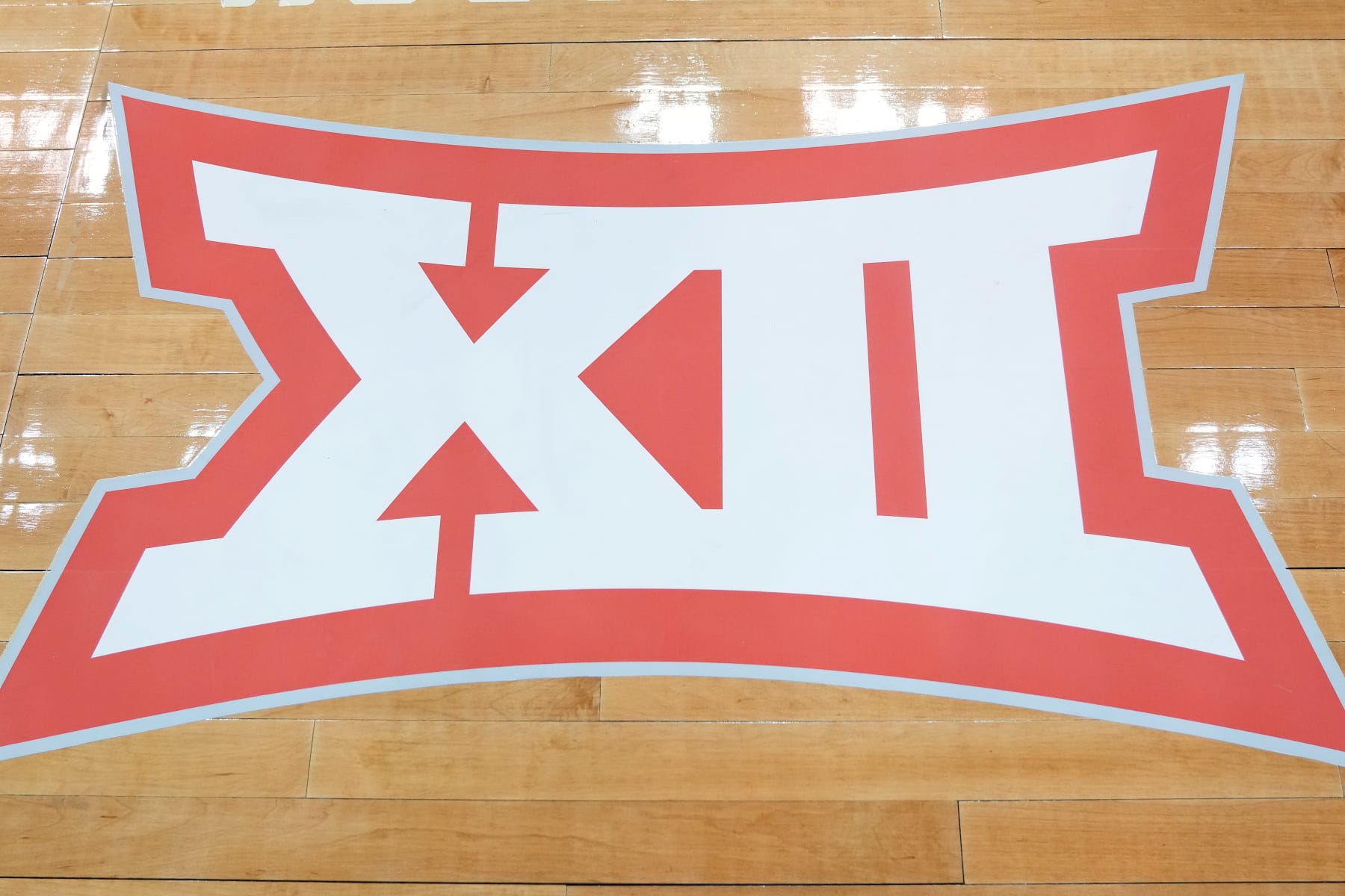 KANSAS CITY, MISSOURI - MARCH 24:  The Big XII logo on the floor during the Sweet 16 round of the NCAA Men's Basketball Tournament game between the Miami (Fl) Hurricanes and the Houston Cougars at T-Mobile Center on March 24, 2023 in Kansas City, Missouri.  (Photo by Mitchell Layton/Getty Images)