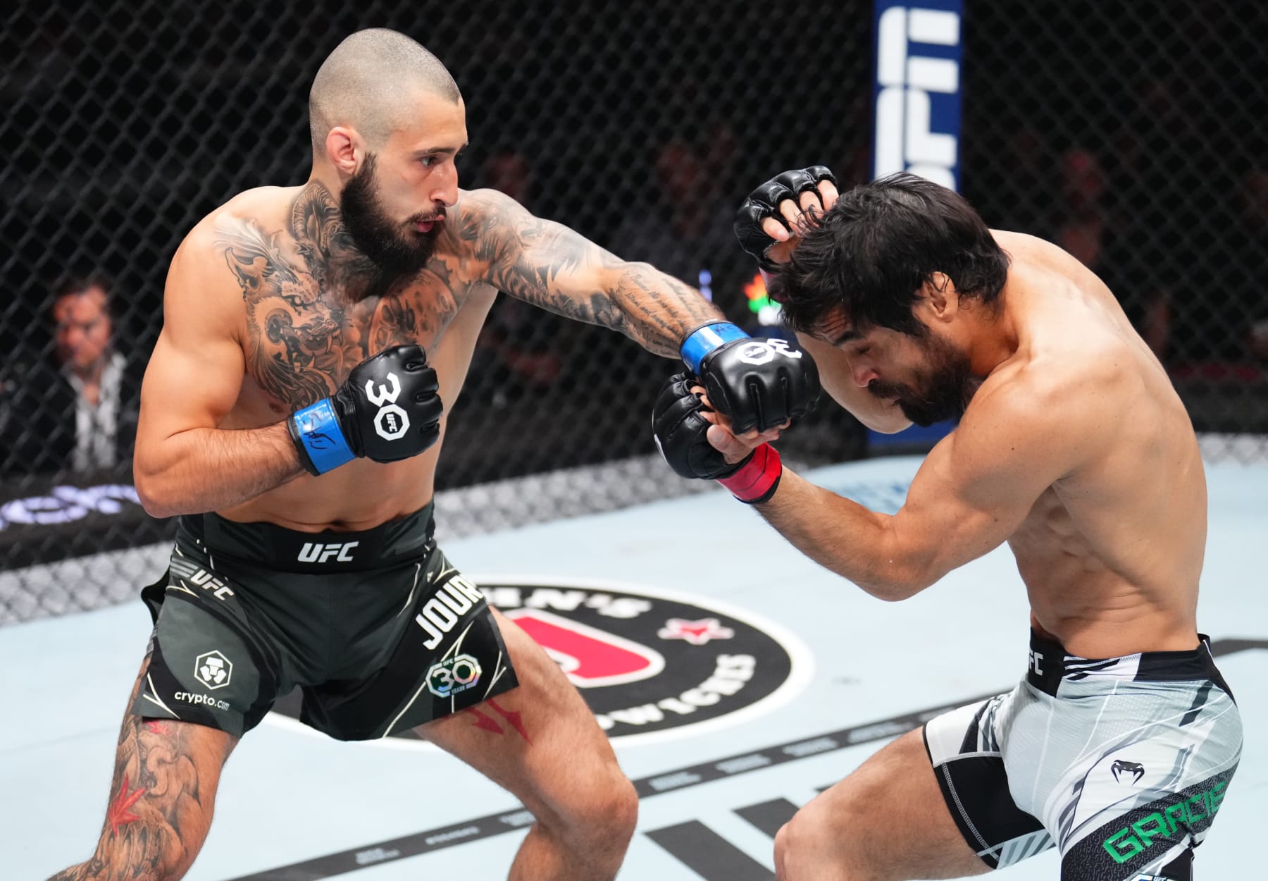 NEWARK, NEW JERSEY - MAY 06: (L-R) Charles Jourdain of Canada punches Kron Gracie of Brazil in a featherweight fight during the UFC 288 event at Prudential Center on May 06, 2023 in Newark, New Jersey. (Photo by Chris Unger/Zuffa LLC via Getty Images) NEWARK, NEW JERSEY - MAY 06: (L-R) Charles Jourdain of Canada punches Kron Gracie of Brazil in a featherweight fight during the UFC 288 event at Prudential Center on May 06, 2023 in Newark, New Jersey. (Photo by Chris Unger/Zuffa LLC via Getty Images)