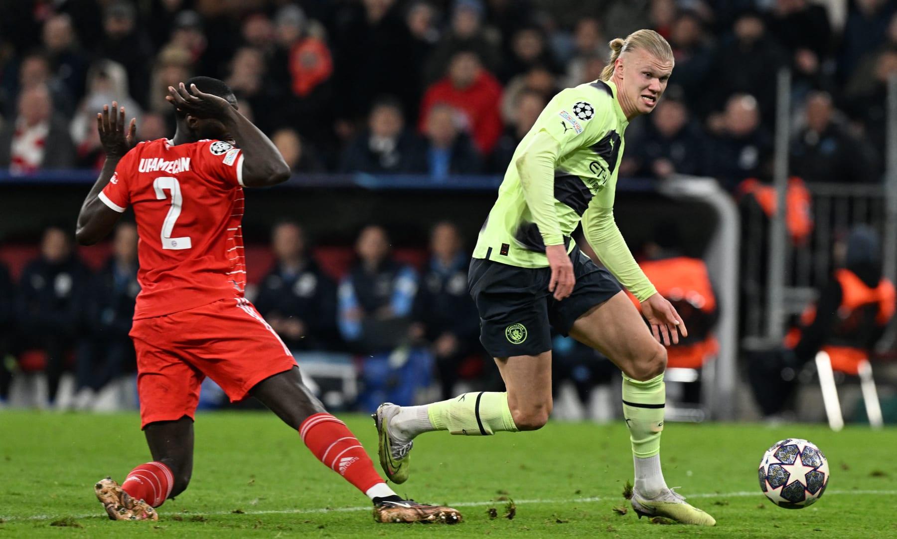 Manchester City's Norwegian striker Erling Haaland (R) runs past Bayern Munich's French defender Dayot Upamecano and towards the goal as he prepares to score the 0-1 opening goal during the UEFA Champions League quarter-final, second leg football match between Bayern Munich and Manchester City in Munich, southern Germany on April 19, 2023. (Photo by CHRISTOF STACHE / AFP) (Photo by CHRISTOF STACHE/AFP via Getty Images)