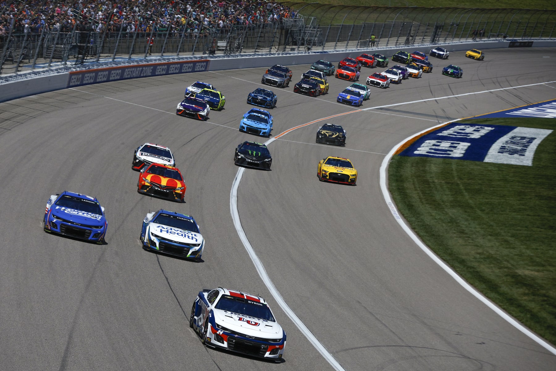 KANSAS CITY, KANSAS - MAY 07: William Byron, driver of the #24 Liberty University Chevrolet, Ross Chastain, driver of the #1 AdventHealth Chevrolet, Kyle Larson, driver of the #5 HendrickCars.com Chevrolet, Tyler Reddick, driver of the #45 McDonald's Toyota, and Martin Truex Jr., driver of the #19 Reser's Fine Foods Toyota, race during the NASCAR Cup Series Advent Health 400 at Kansas Speedway on May 07, 2023 in Kansas City, Kansas. (Photo by Sean Gardner/Getty Images)