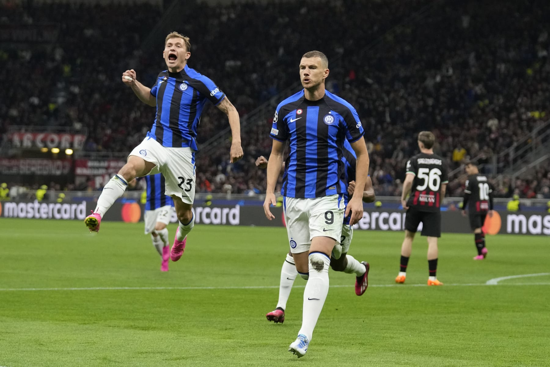 Inter Milan's Edin Dzeko, right, celebrates after scoring his side's opening goal during the Champions League semifinal first leg soccer match between AC Milan and Inter Milan at the San Siro stadium in Milan, Italy, Wednesday, May 10, 2023. (AP Photo/Antonio Calanni)