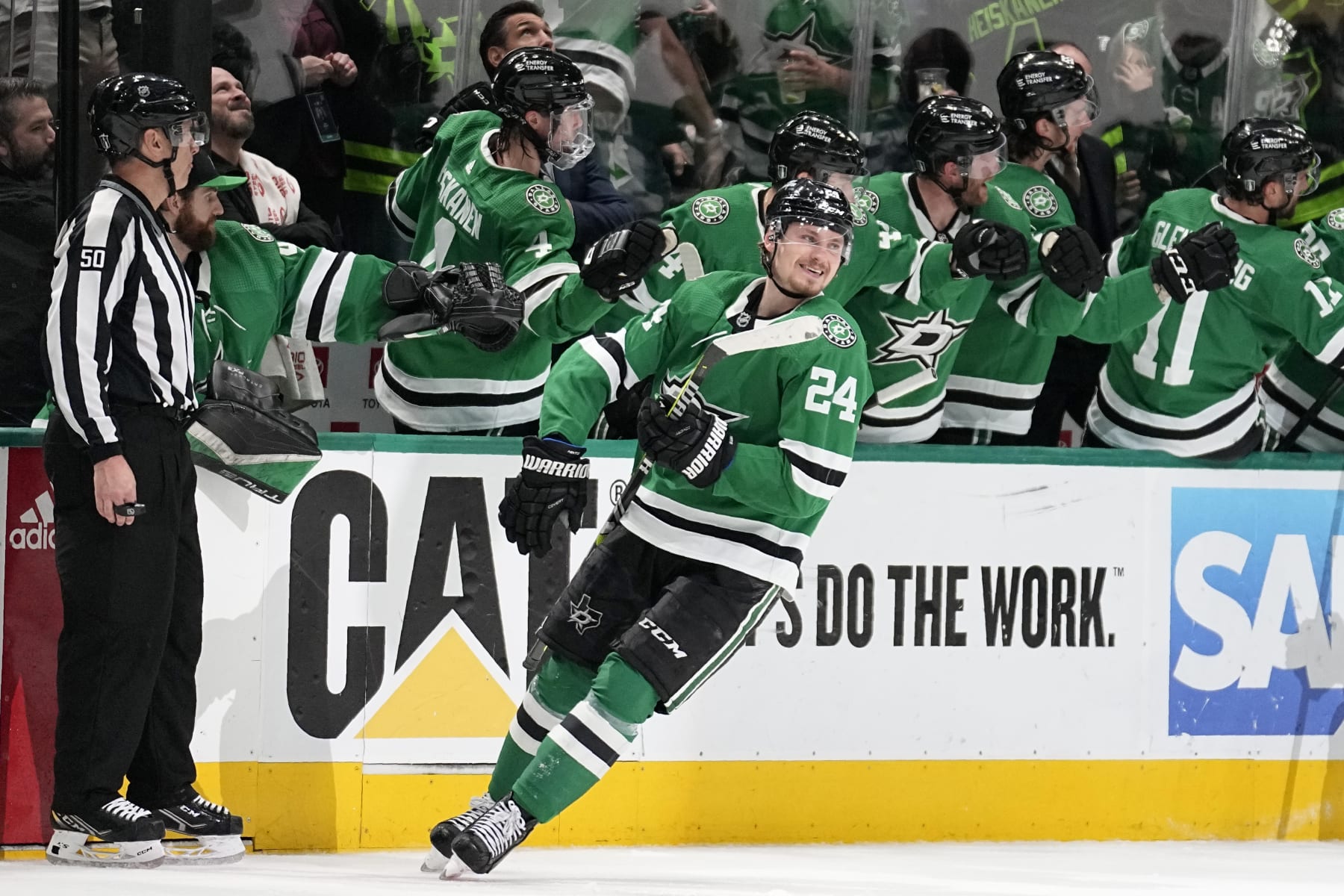 Dallas Stars center Roope Hintz (24) smiles as he celebrates with the bench after scoring against the Seattle Kraken in the second period of Game 7 of an NHL hockey Stanley Cup second-round playoff series, Monday, May 15, 2023, in Dallas. (AP Photo/Tony Gutierrez)