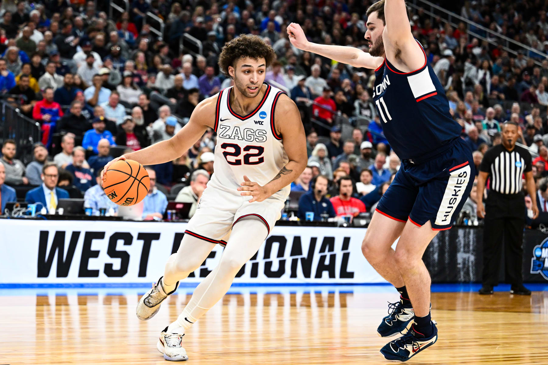 LAS VEGAS, NV - MARCH 25: Anton Watson #22 of the Gonzaga Bulldogs handles the ball against Alex Karaban #11 of the Connecticut Huskies of the Connecticut Huskies during the Elite Eight round of the 2023 NCAA Men's Basketball Tournament held at T-Mobile Arena on March 25, 2023 in Las Vegas, Nevada. (Photo by Brett Wilhelm/NCAA Photos via Getty Images)