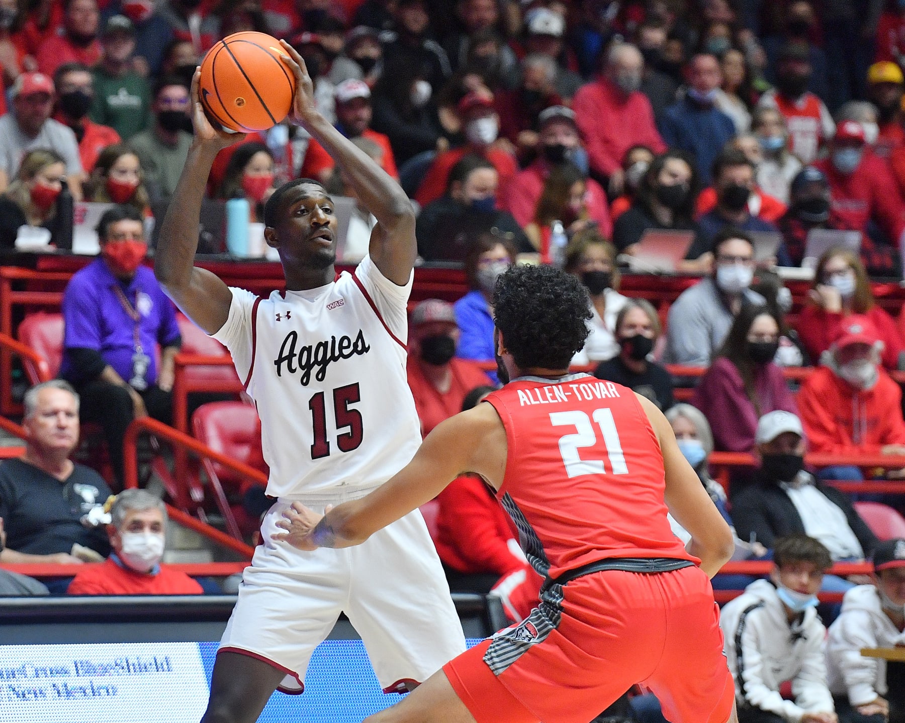 ALBUQUERQUE, NEW MEXICO - DECEMBER 06: Mike Peake #15 of the New Mexico State Aggies looks to pass against Jay Allen-Tovar #21 of the New Mexico Lobos during their game at The Pit on December 06, 2021 in Albuquerque, New Mexico. (Photo by Sam Wasson/Getty Images)