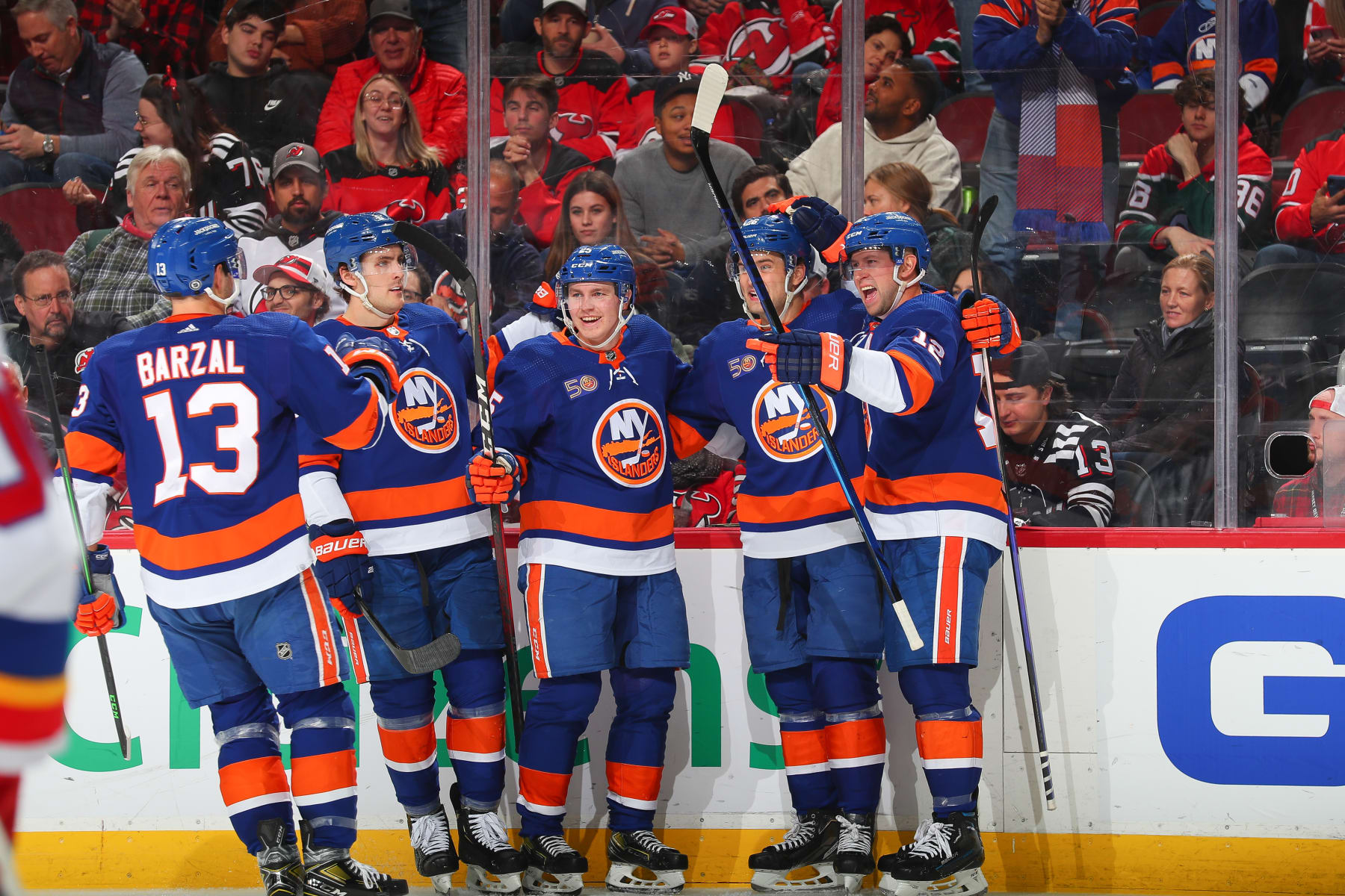 NEWARK, NJ - DECEMBER 09: Oliver Wahlstrom #26 of the New York Islanders celebrates his goal with teammates in the second period of the game against the New Jersey Devils on December 09, 2022 at the Prudential Center in Newark, New Jersey. (Photo by Rich Graessle/NHLI via Getty Images)