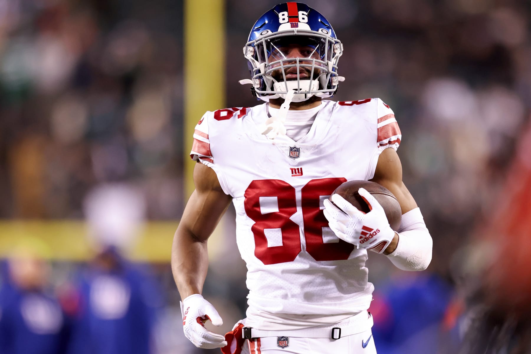 Isaiah Hodgins of the New York Giants runs the ball while being News  Photo - Getty Images