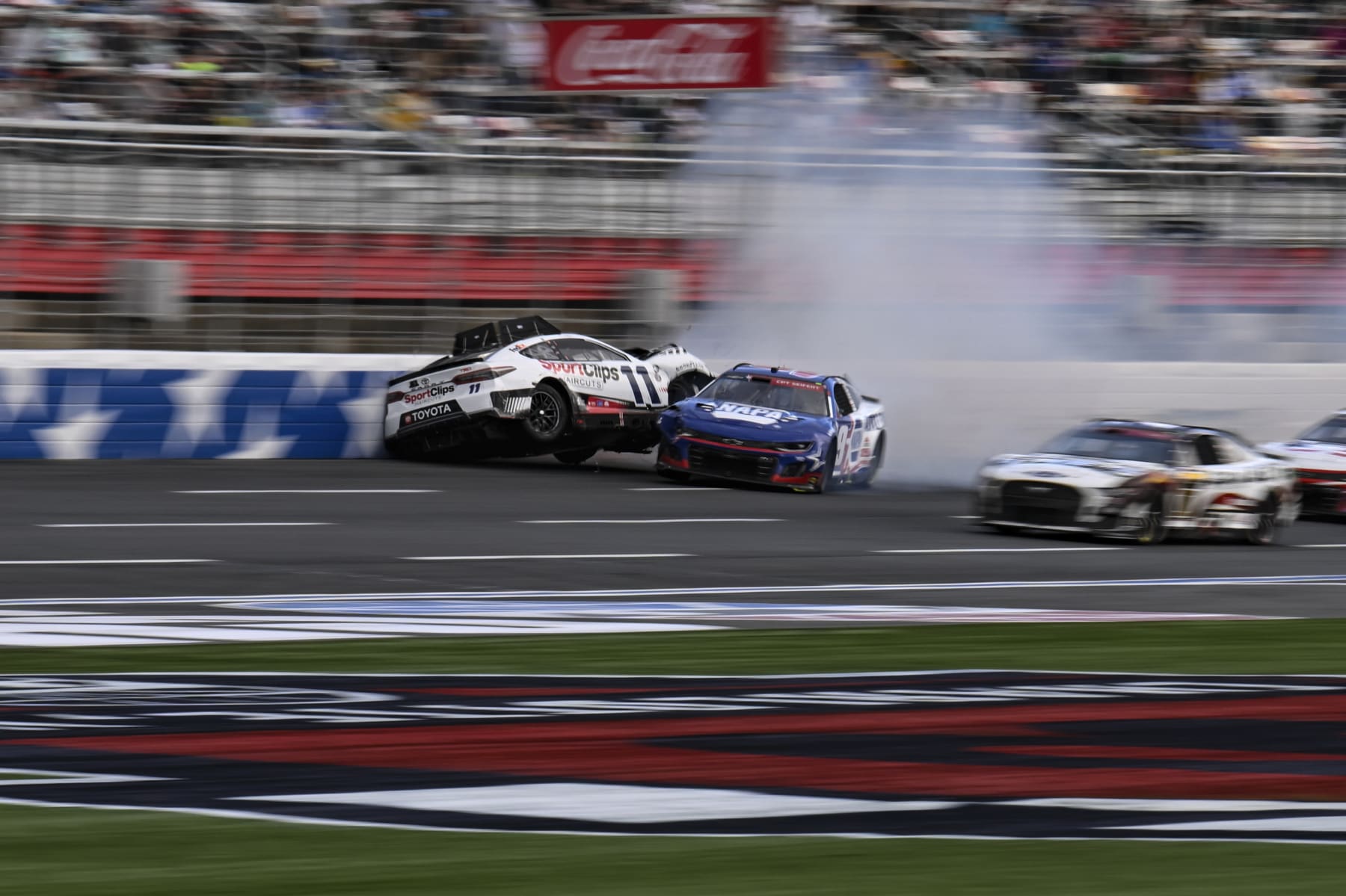 Chase Elliott (9) and Denny Hamlin (11) collide during a NASCAR Cup Series auto race at Charlotte Motor Speedway, Monday, May 29, 2023, in Concord, N.C. (AP Photo/Matt Kelley)