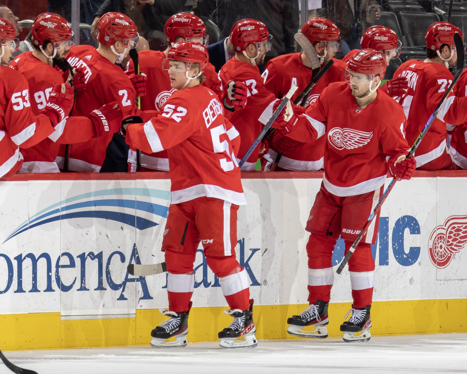 DETROIT, MI - MARCH 02: Jonatan Berggren #52 and Filip Zadina #11 of the Detroit Red Wings pounds gloves with with teammates on the bench during the second period of an NHL game against the Seattle Kraken at Little Caesars Arena on March 2, 2023 in Detroit, Michigan. (Photo by Dave Reginek/NHLI via Getty Images)
