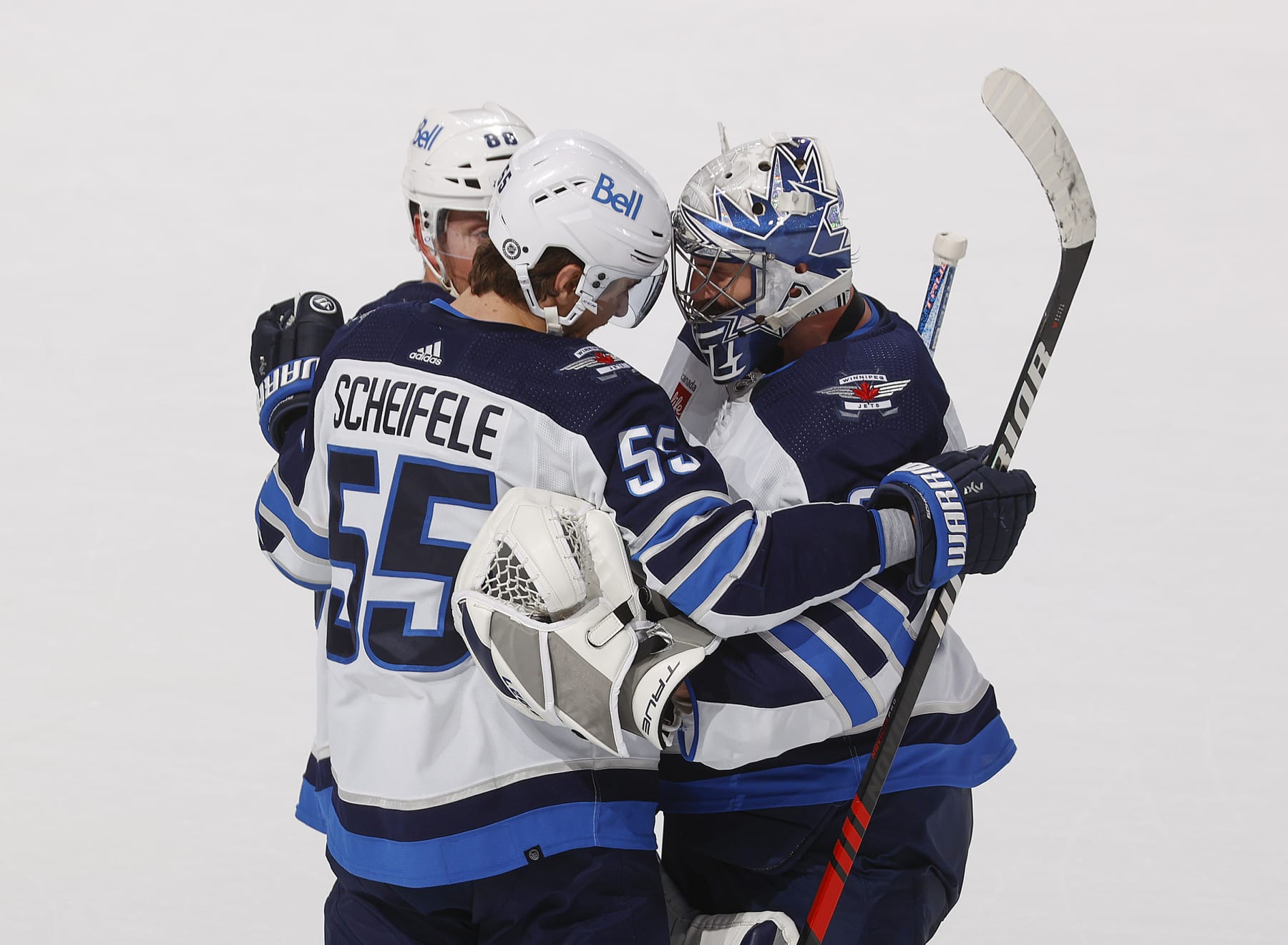 Winnipeg Jets center Mark Scheifele (left) and goaltender Connor Hellebuyck.