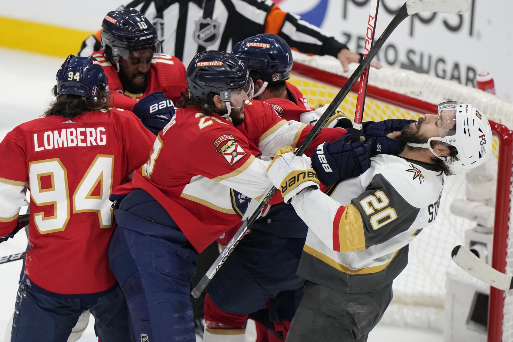 Florida Panthers defenseman Josh Mahura (28) and Vegas Golden Knights center Chandler Stephenson (20) fight during the third period in Game 4 of the NHL hockey Stanley Cup Finals, Saturday, June 10, 2023, in Sunrise, Fla. (AP Photo/Wilfredo Lee)