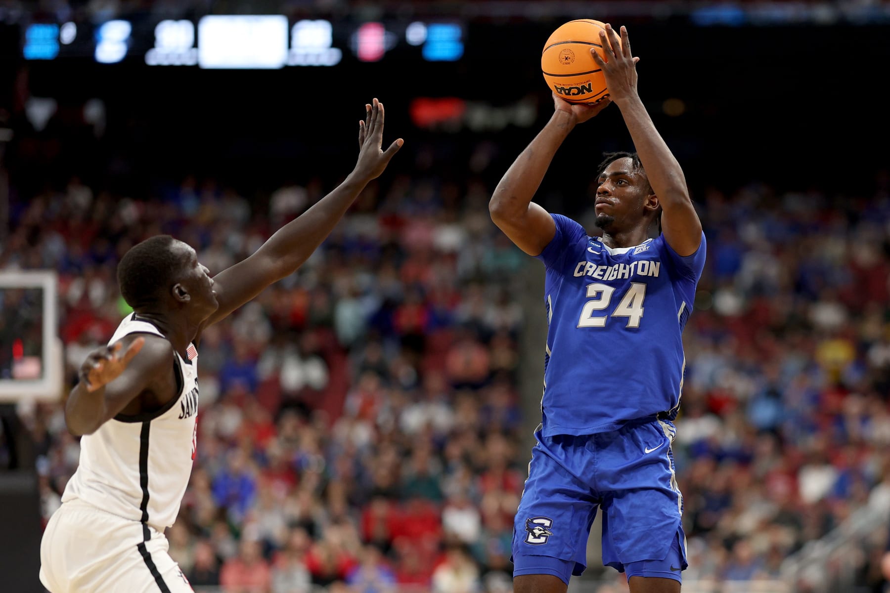 LOUISVILLE, KENTUCKY - MARCH 26: Arthur Kaluma #24 of the Creighton Bluejays shoots a three point basket against Aguek Arop #33 of the San Diego State Aztecs during the first half in the Elite Eight round of the NCAA Men's Basketball Tournament at KFC YUM! Center on March 26, 2023 in Louisville, Kentucky. (Photo by Rob Carr/Getty Images)
