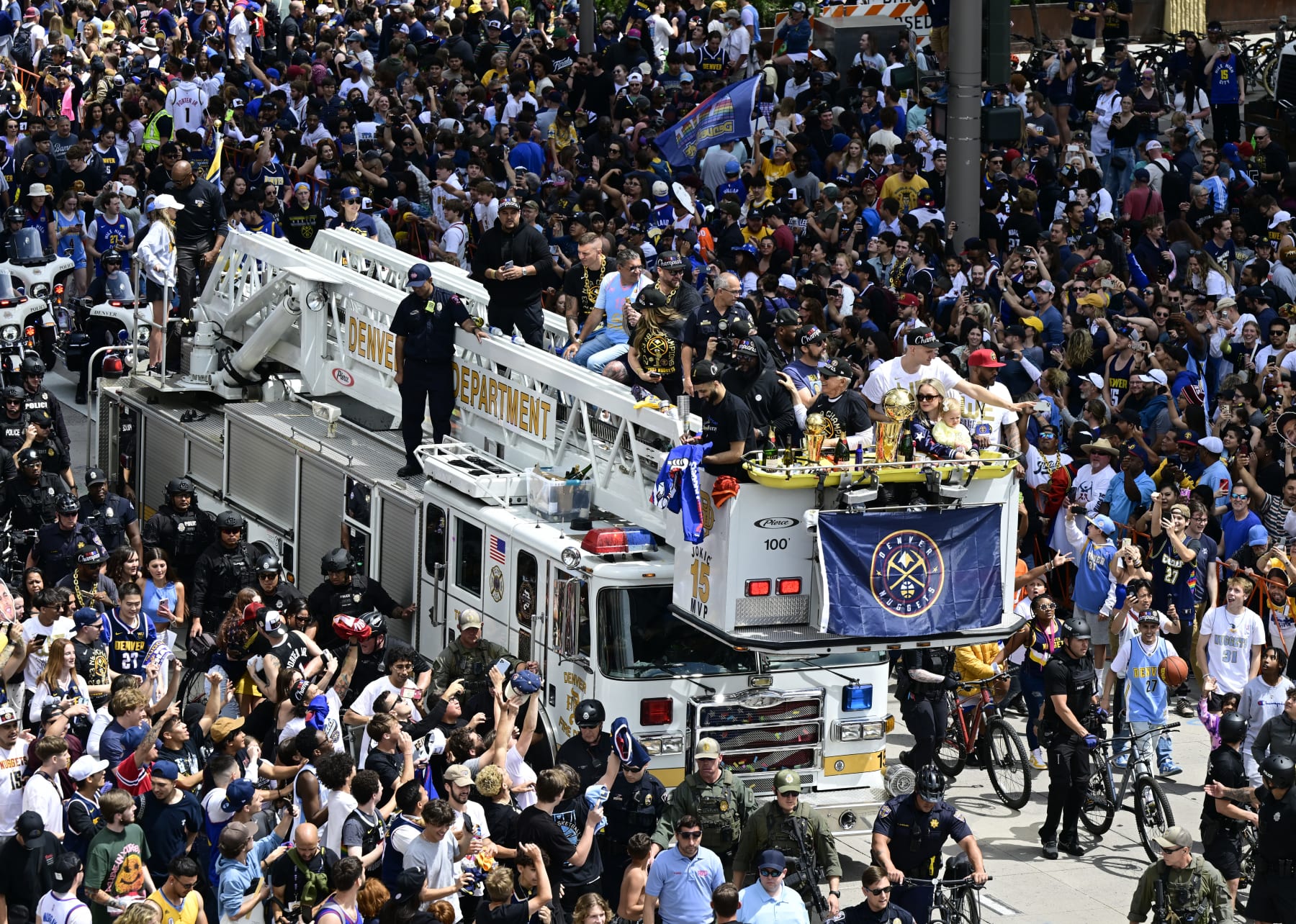 DENVER, CO - JUNE 15: Denver Nuggets players Jamal Murray, left, and Nikola Jokic, right, along with family and the Kroenkes ride atop  Denver Fire truck #15 along the Nuggets Championship parade route on their way to Civic Center Park June 15, 2023. The Denver Nuggets defeated the Miami Heat in five games to with their first ever NBA championship. (Photo by Andy Cross/MediaNews Group/The Denver Post via Getty Images)