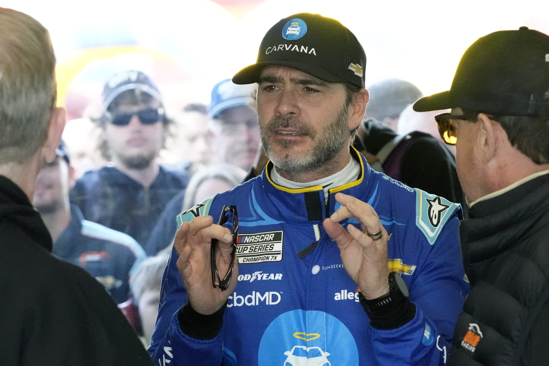 Jimmie Johnson talks to team members in his garage after a practice session for the NASCAR Daytona 500 auto race at Daytona International Speedway, Saturday, Feb. 18, 2023, in Daytona Beach, Fla. (AP Photo/John Raoux)