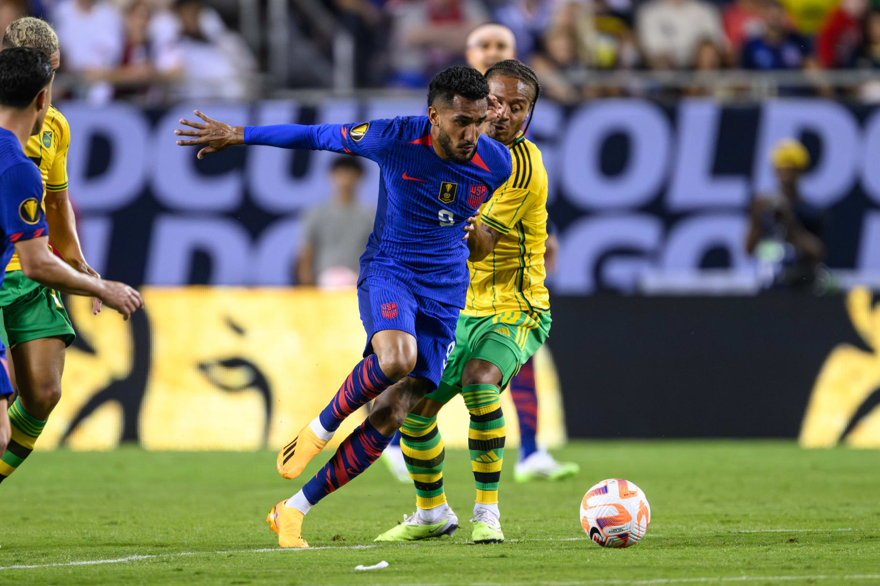 CHICAGO, IL - JUNE 24: Jesus Ferreira #9 of the United States plays the ball as Bobby Decordova-Reid #10 of Jamaica defends during a game between Jamaica and USMNT at Soldier Field on June 24, 2023 in Chicago, Illinois. (Photo by Daniel Bartel/ISI Photos/Getty Images)