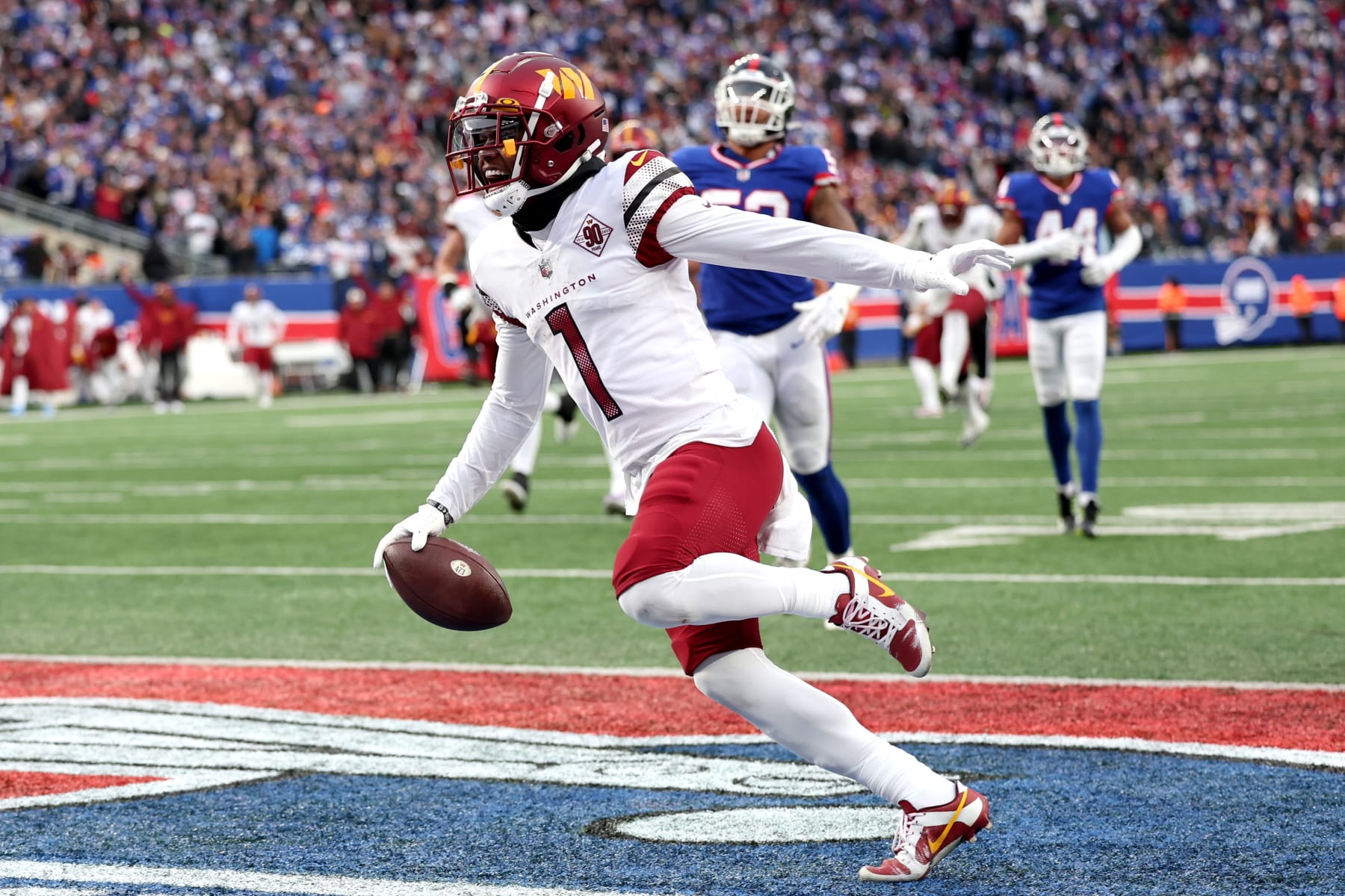 EAST RUTHERFORD, NEW JERSEY - DECEMBER 04: Jahan Dotson #1 of the Washington Commanders scores a touchdown in the fourth quarter of a game against the New York Giants at MetLife Stadium on December 04, 2022 in East Rutherford, New Jersey. (Photo by Al Bello/Getty Images)