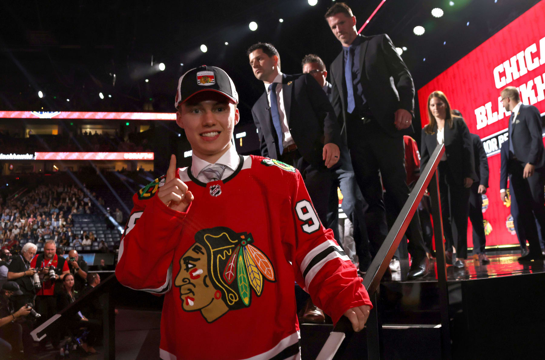 NASHVILLE, TENNESSEE - JUNE 28: Connor Bedard raises a forefinger after being selected first overall by the Chicago Blackhawks during the 2023 Upper Deck NHL Draft - Round One at Bridgestone Arena on June 28, 2023 in Nashville, Tennessee. (Photo by Dave Sandford/NHLI via Getty Images)
